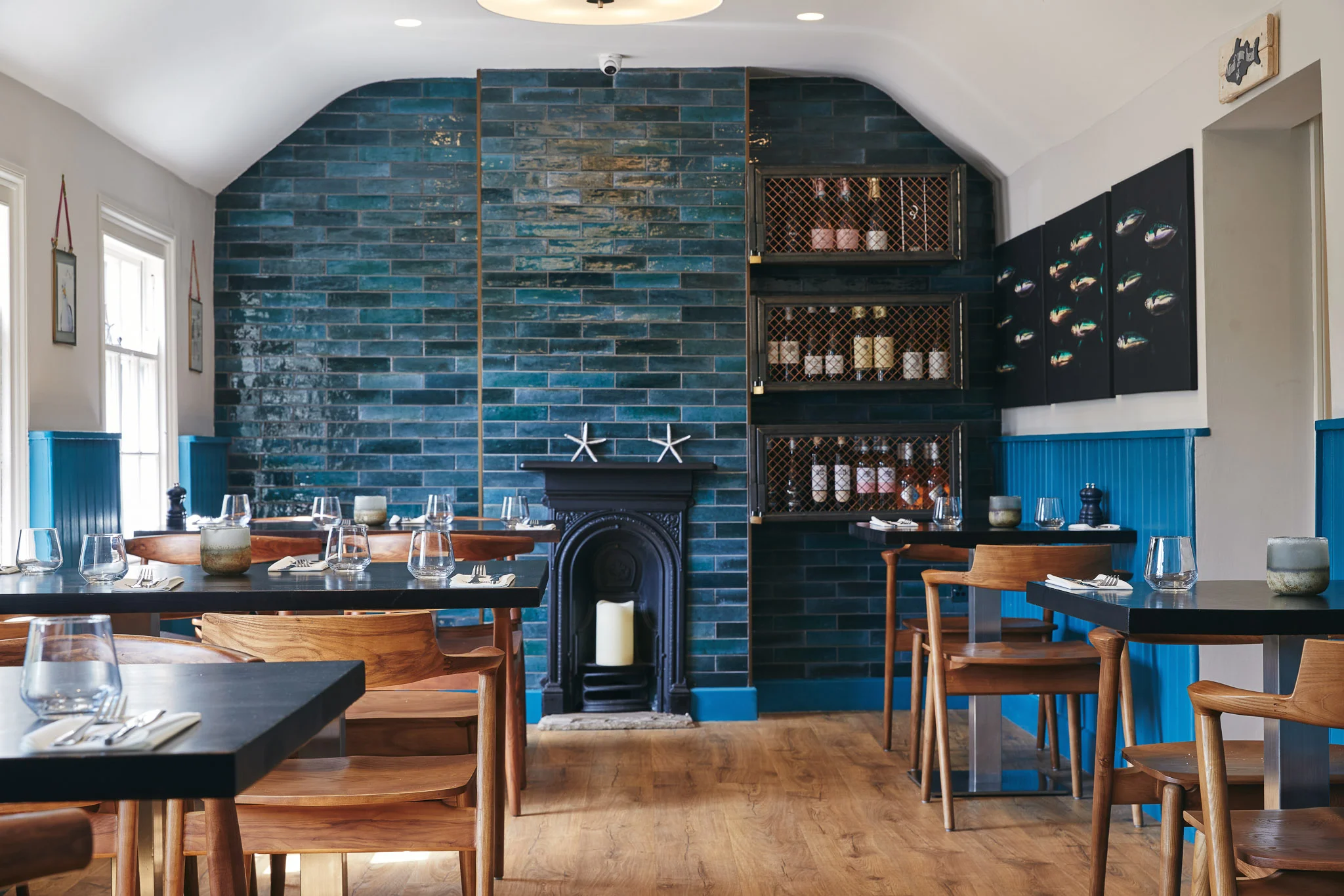 Stylish restaurant interior with blue tiles and wooden furniture