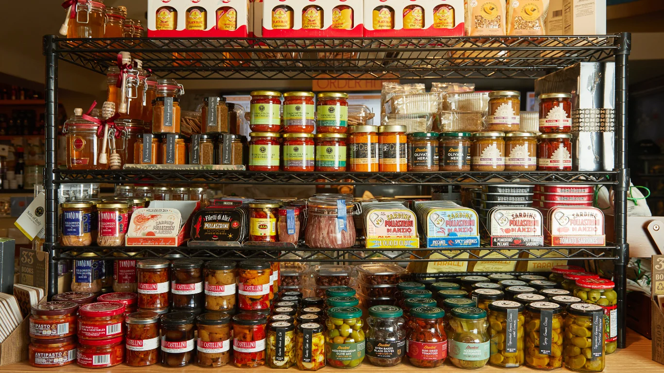 Gourmet pantry shelf filled with artisanal preserves and condiments