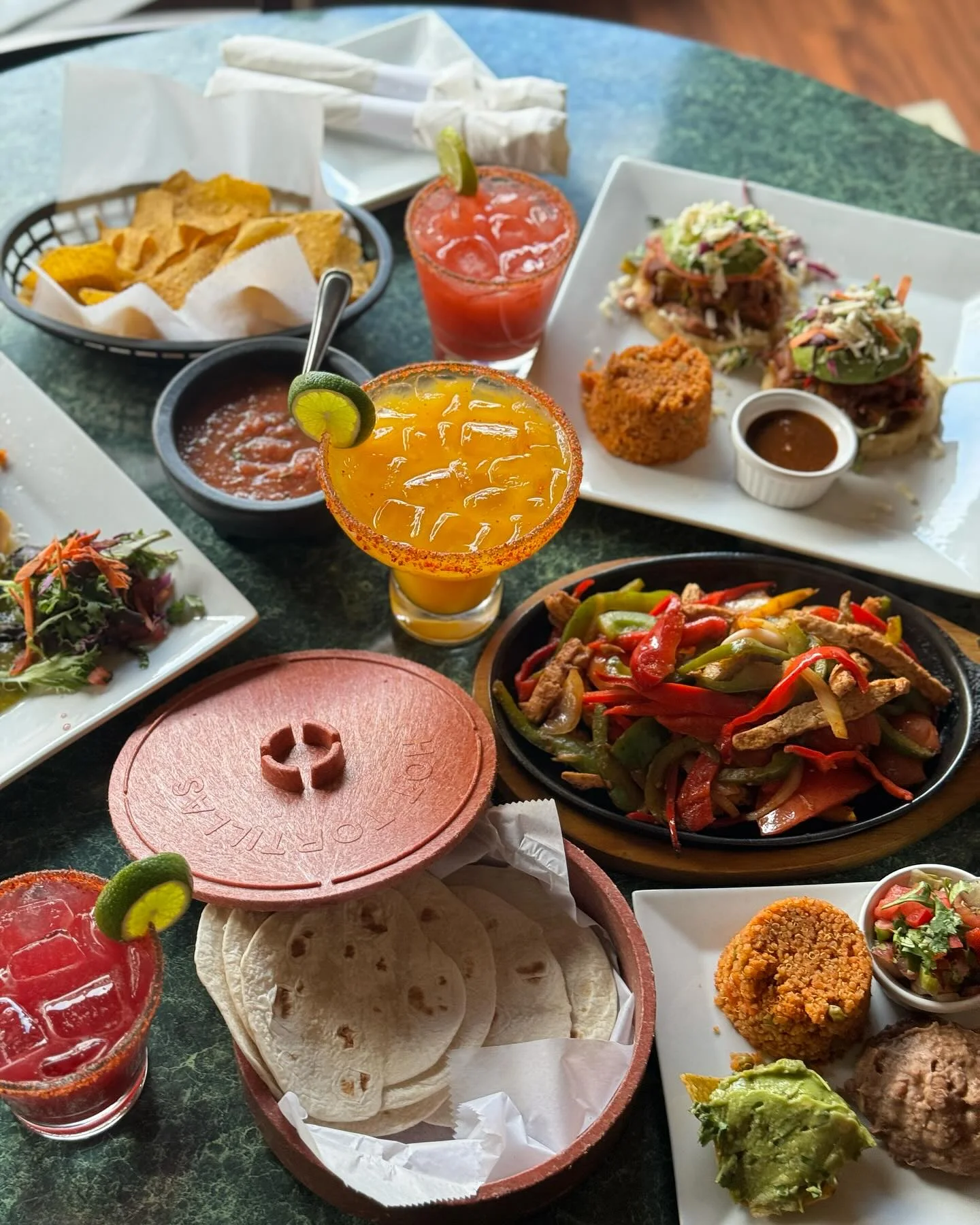 Colorful Mexican feast with fajitas, tacos, and refreshing cocktails