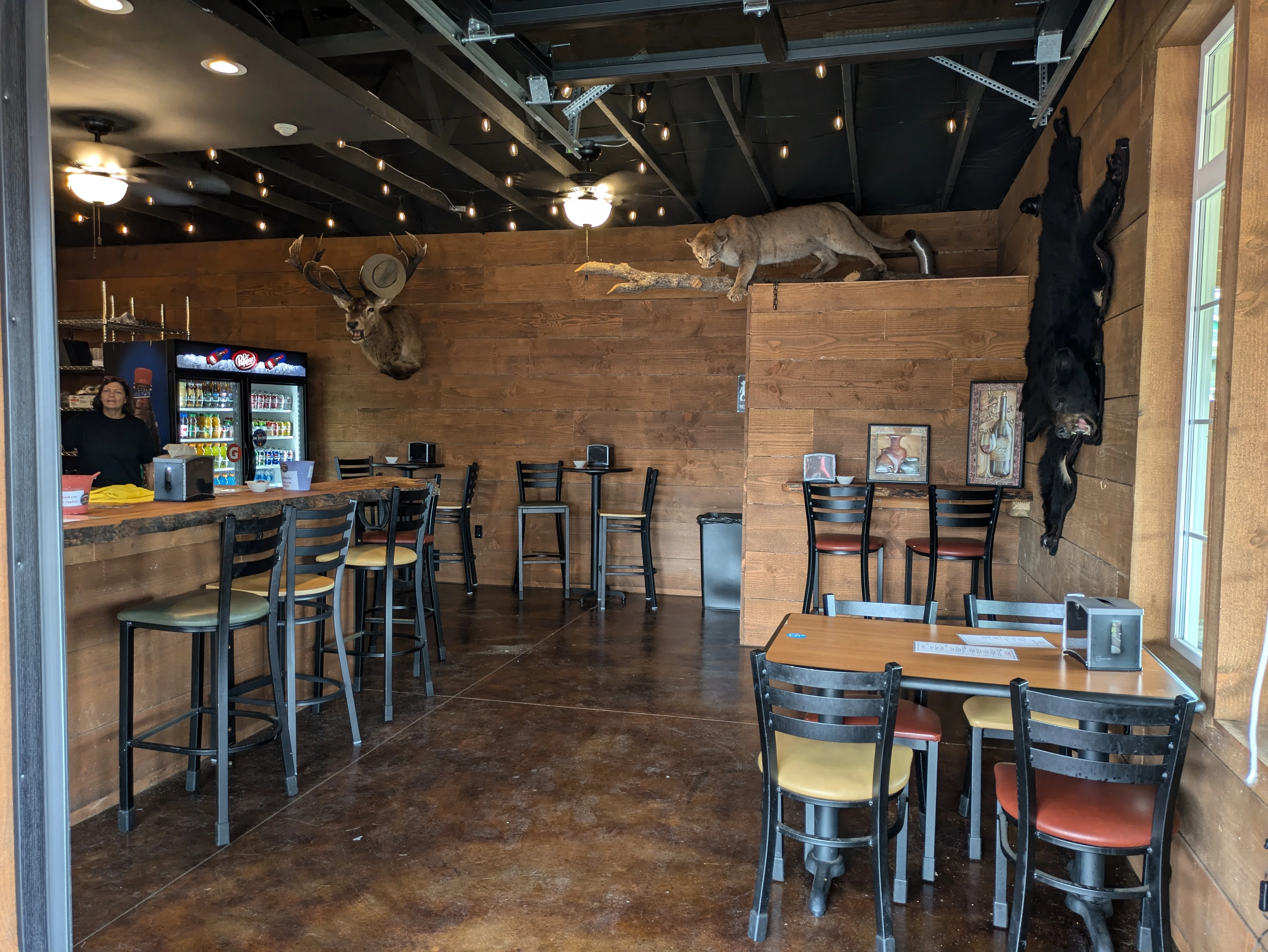 Rustic restaurant interior with animal mounts and bar seating
