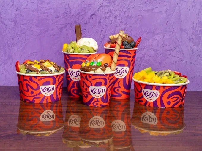 Colorful frozen yogurt cups with toppings