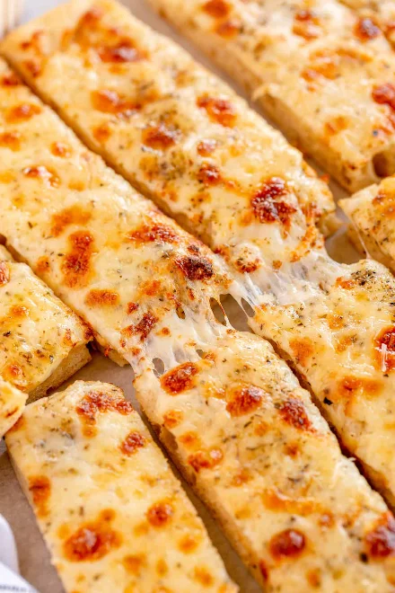 Cheesy garlic breadsticks with melted cheese, a popular Italian appetizer