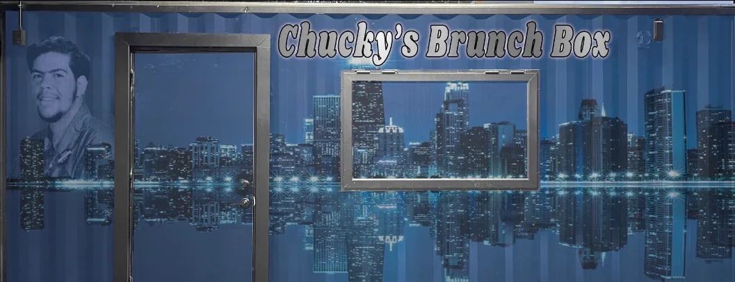 Exterior of Chucky's Brunch Box food truck with city skyline mural