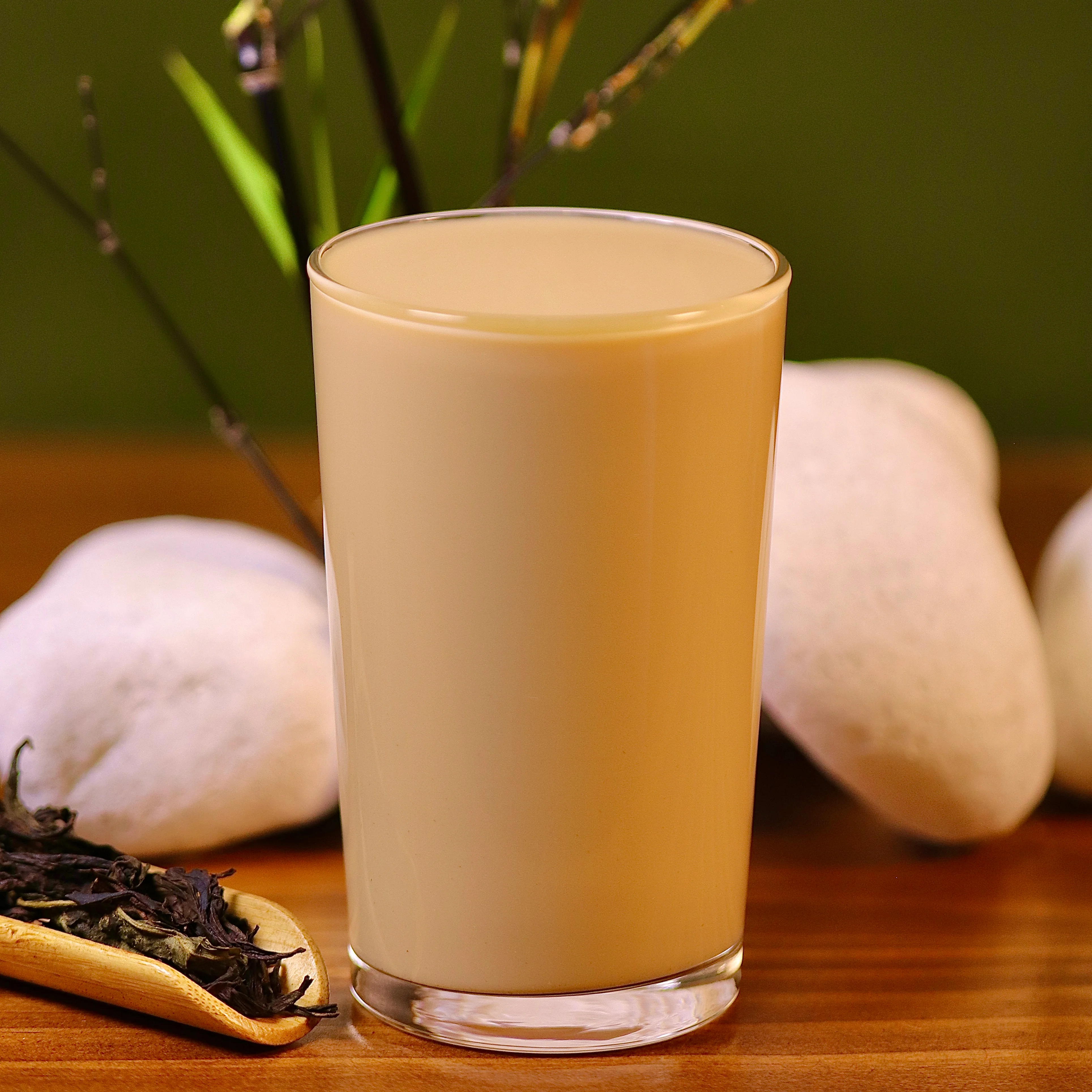 Glass of creamy Indian chai tea on a wooden table