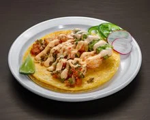 Delicious shrimp tacos with creamy sauce and fresh toppings