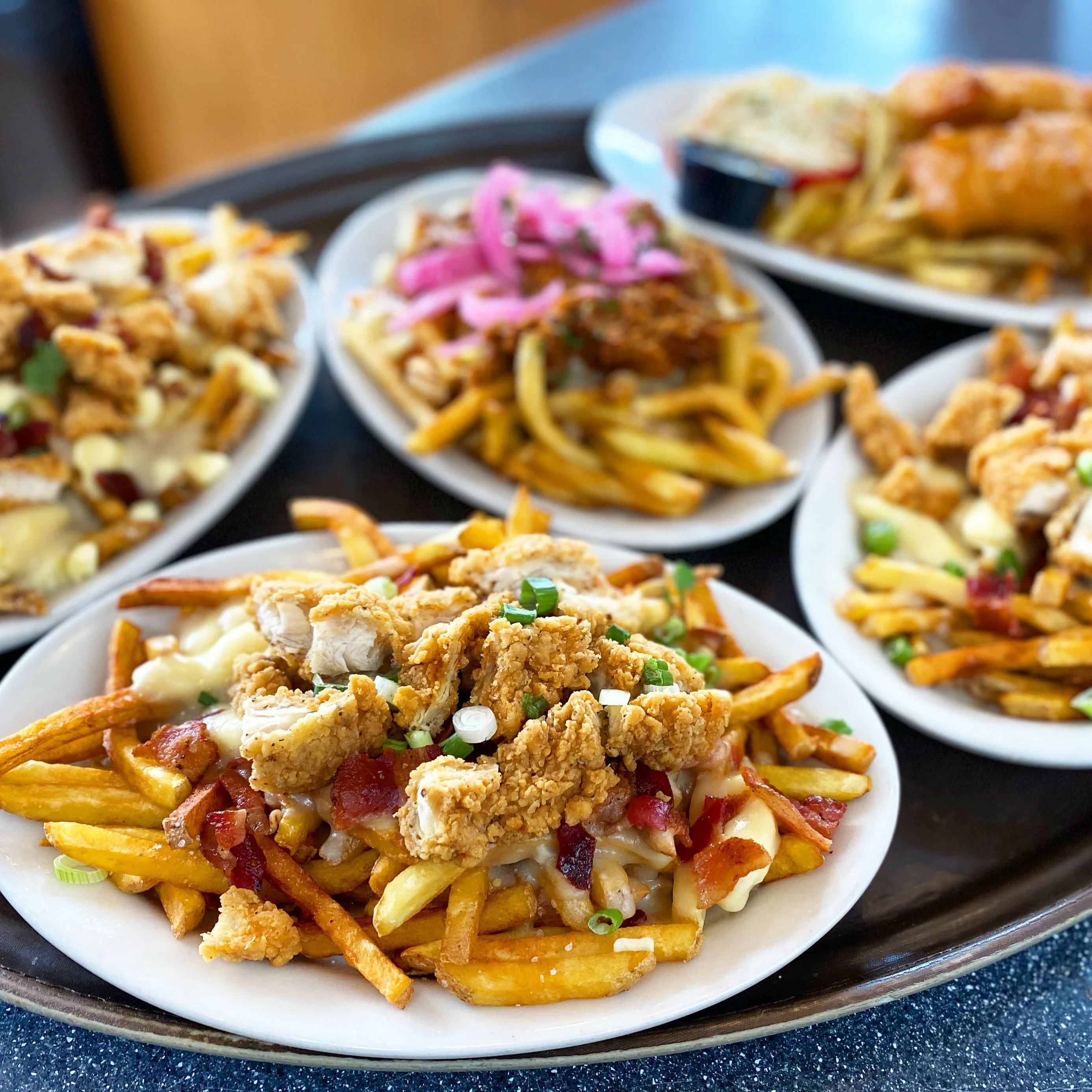 Loaded Canadian poutine with fried chicken and toppings