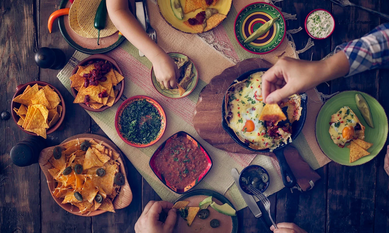 Colorful Mexican feast with nachos and guacamole
