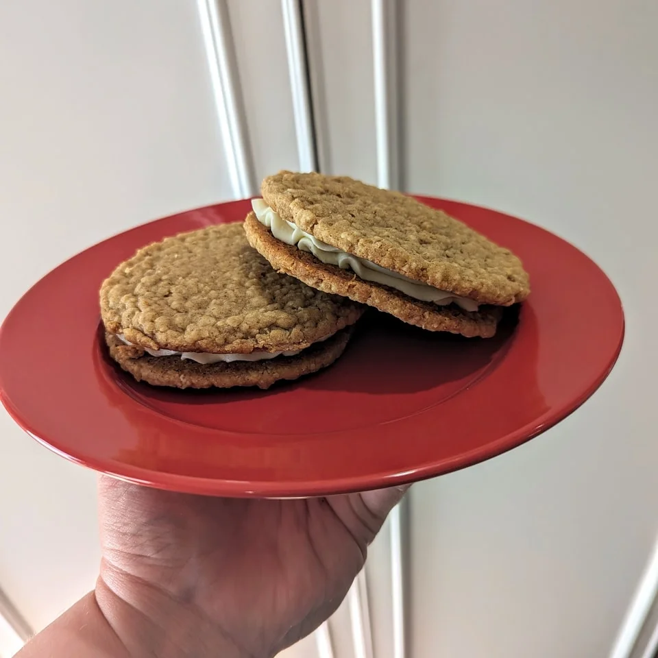 Oatmeal cream pies on a red plate