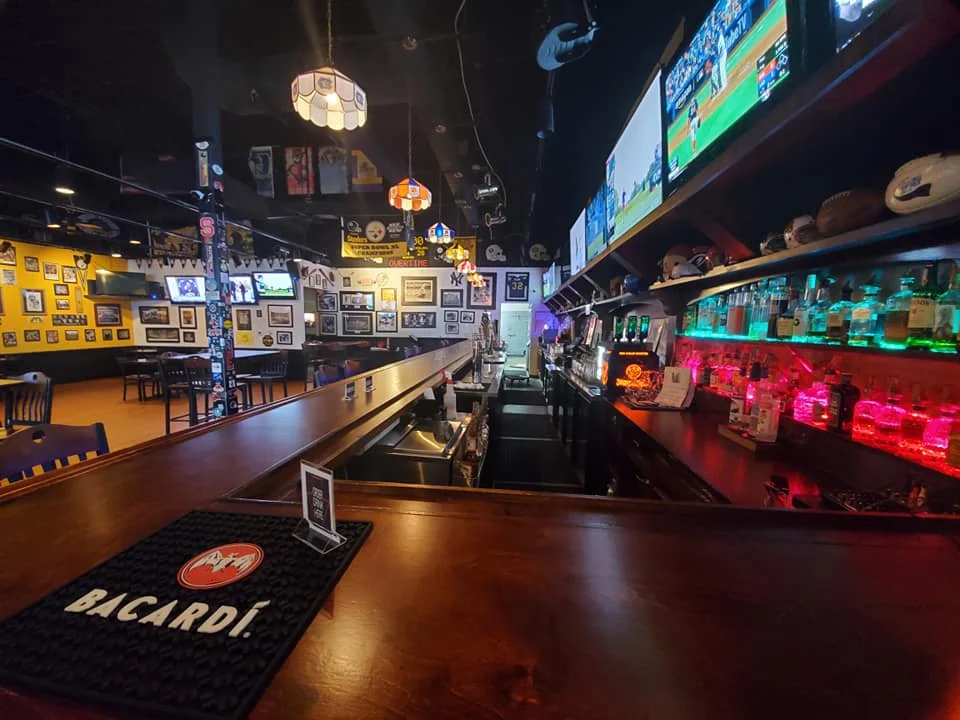 Cozy bar interior with colorful lighting and sports memorabilia