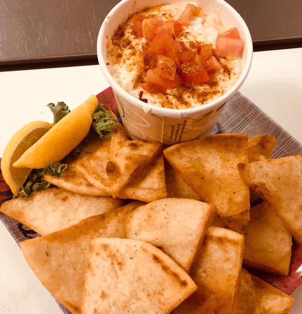 Mediterranean dip with pita chips and fresh toppings