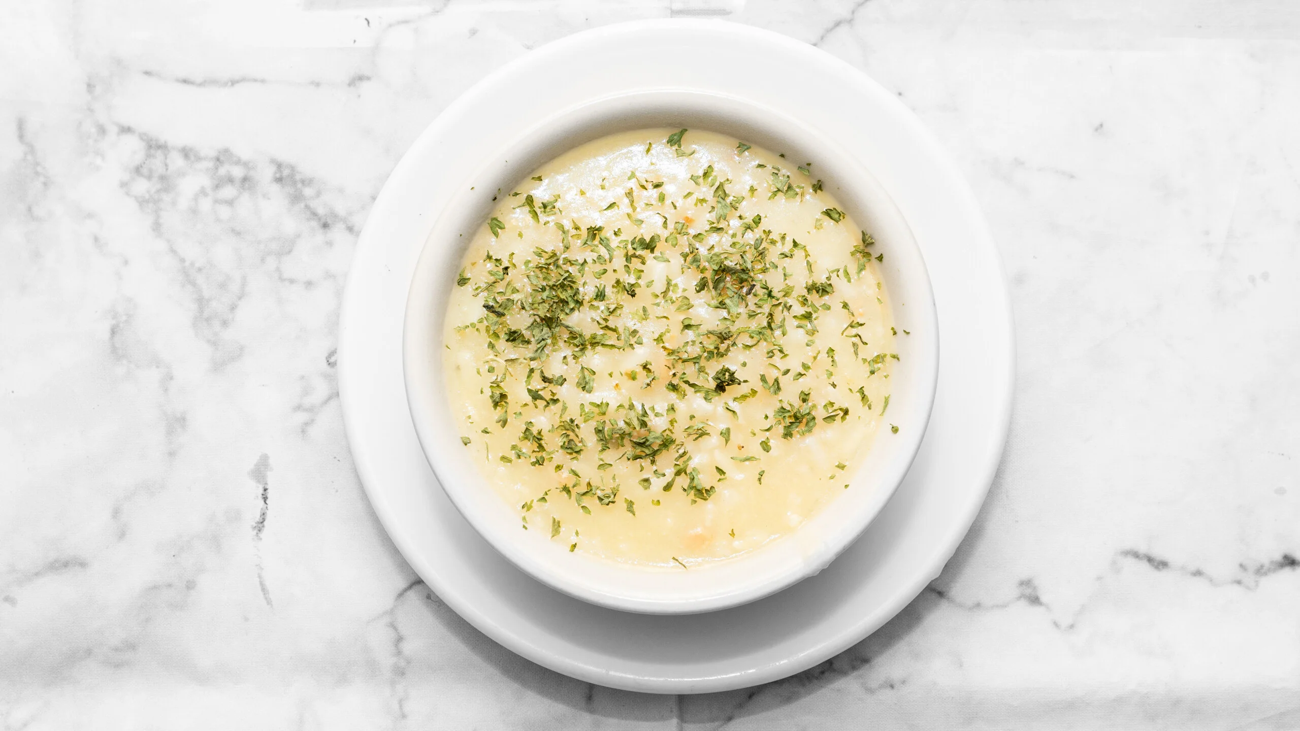 Creamy French onion soup topped with herbs