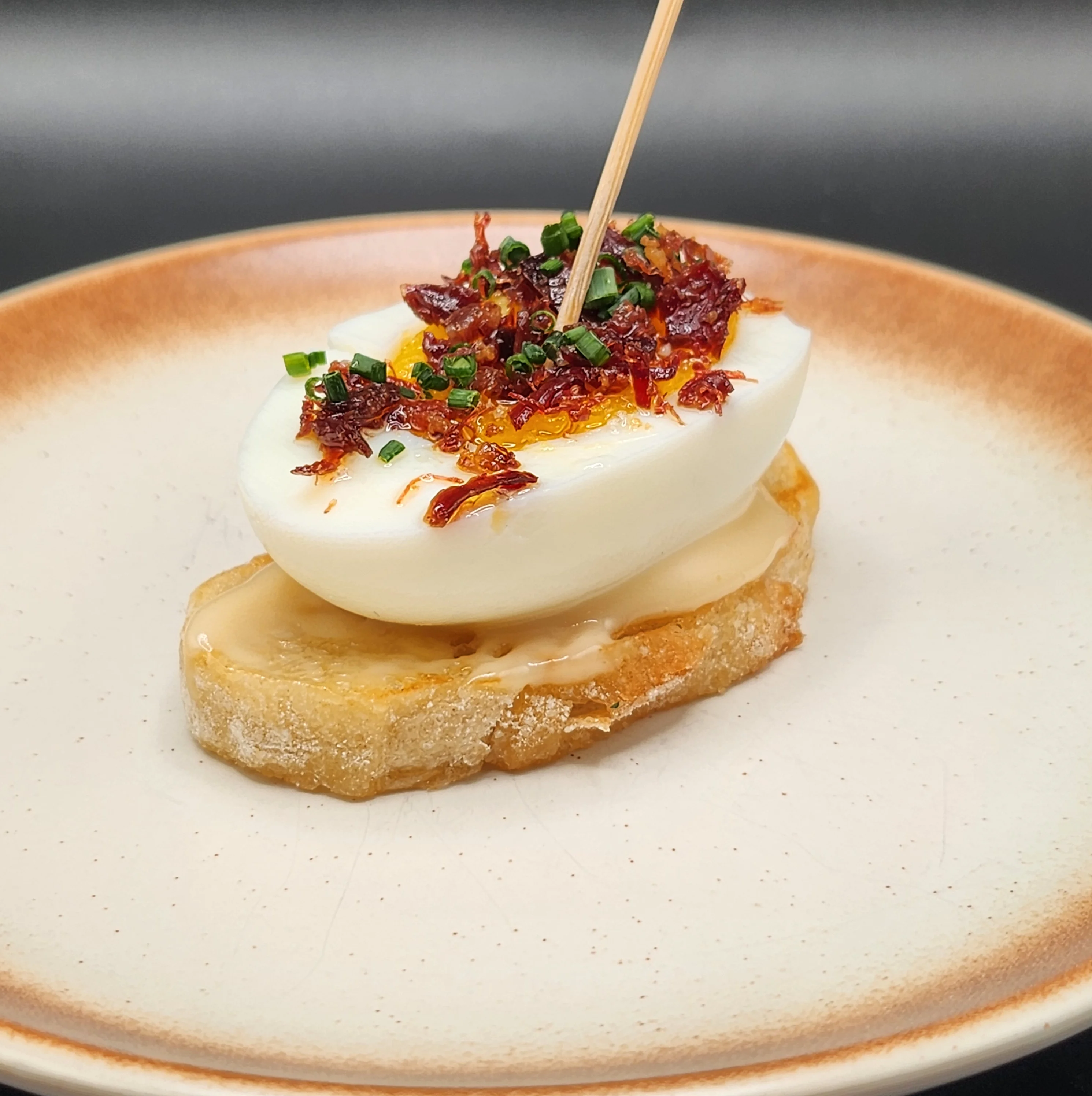 Spanish tapa of soft-boiled egg on toasted bread