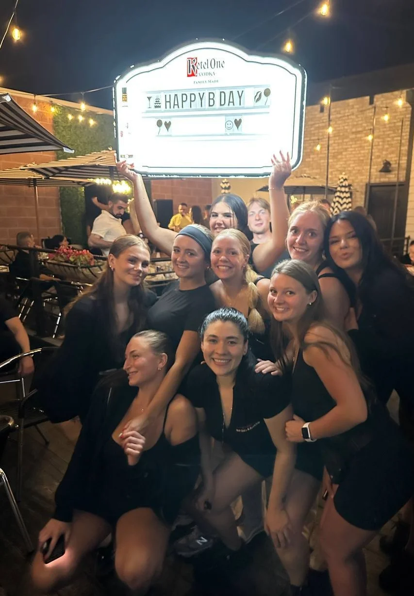 Group of friends celebrating a birthday at a lively restaurant patio