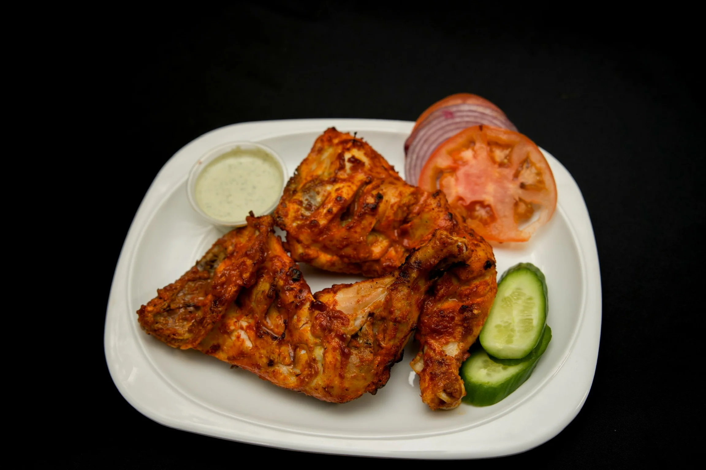 Tandoori chicken served with fresh salad and mint sauce