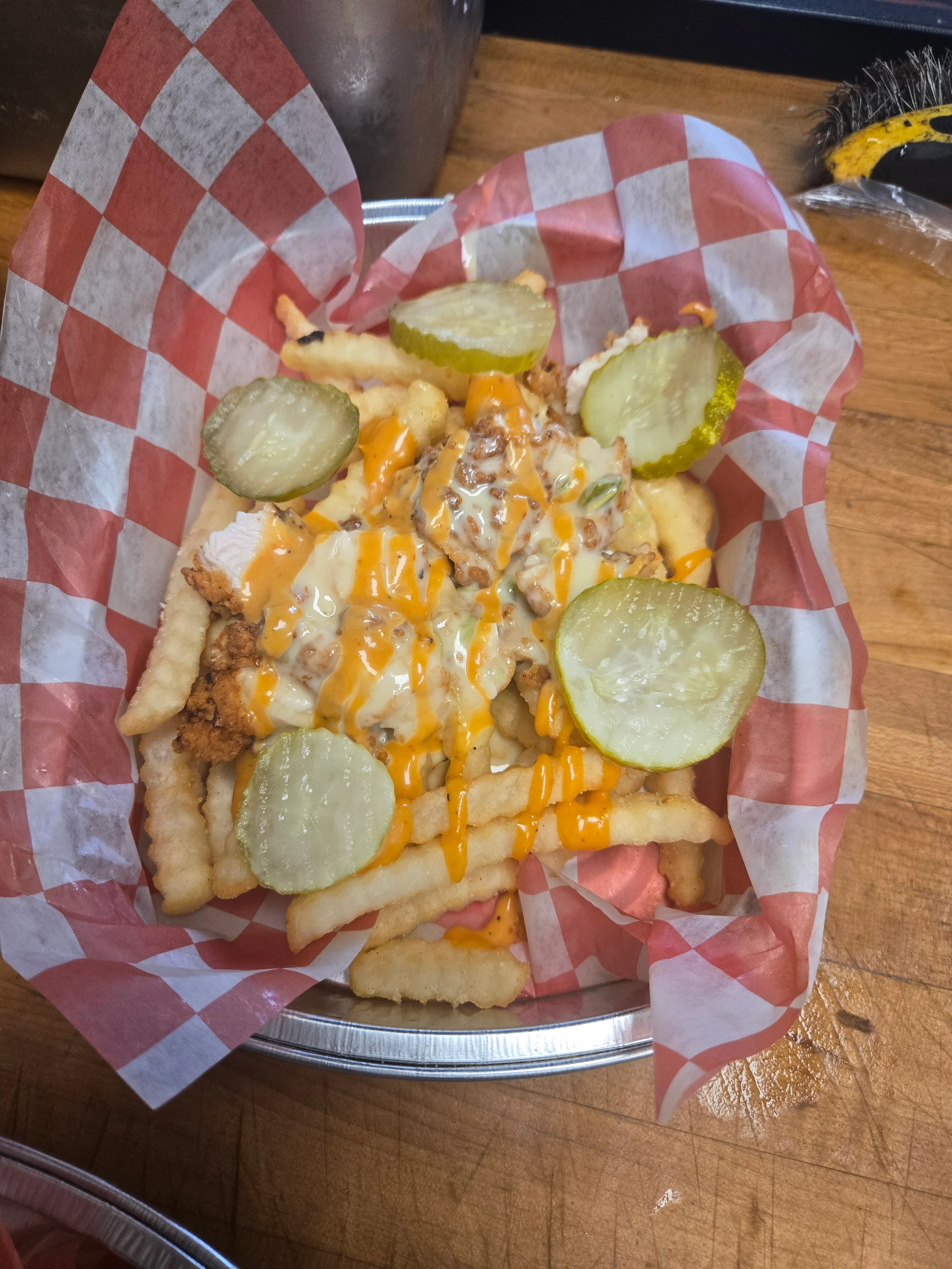 Loaded chicken fries with pickles and cheese sauce