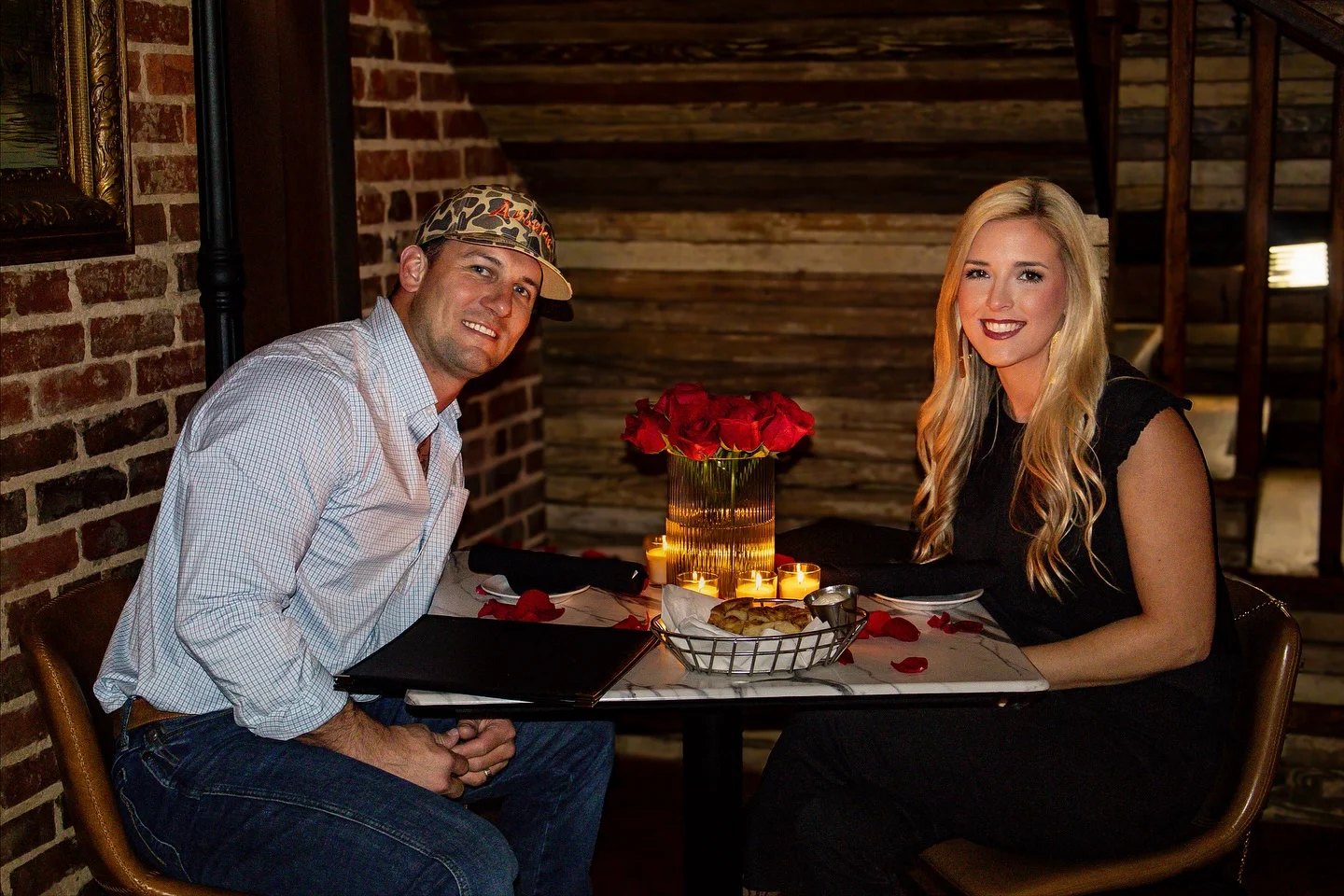 Romantic dinner setting with candles and roses