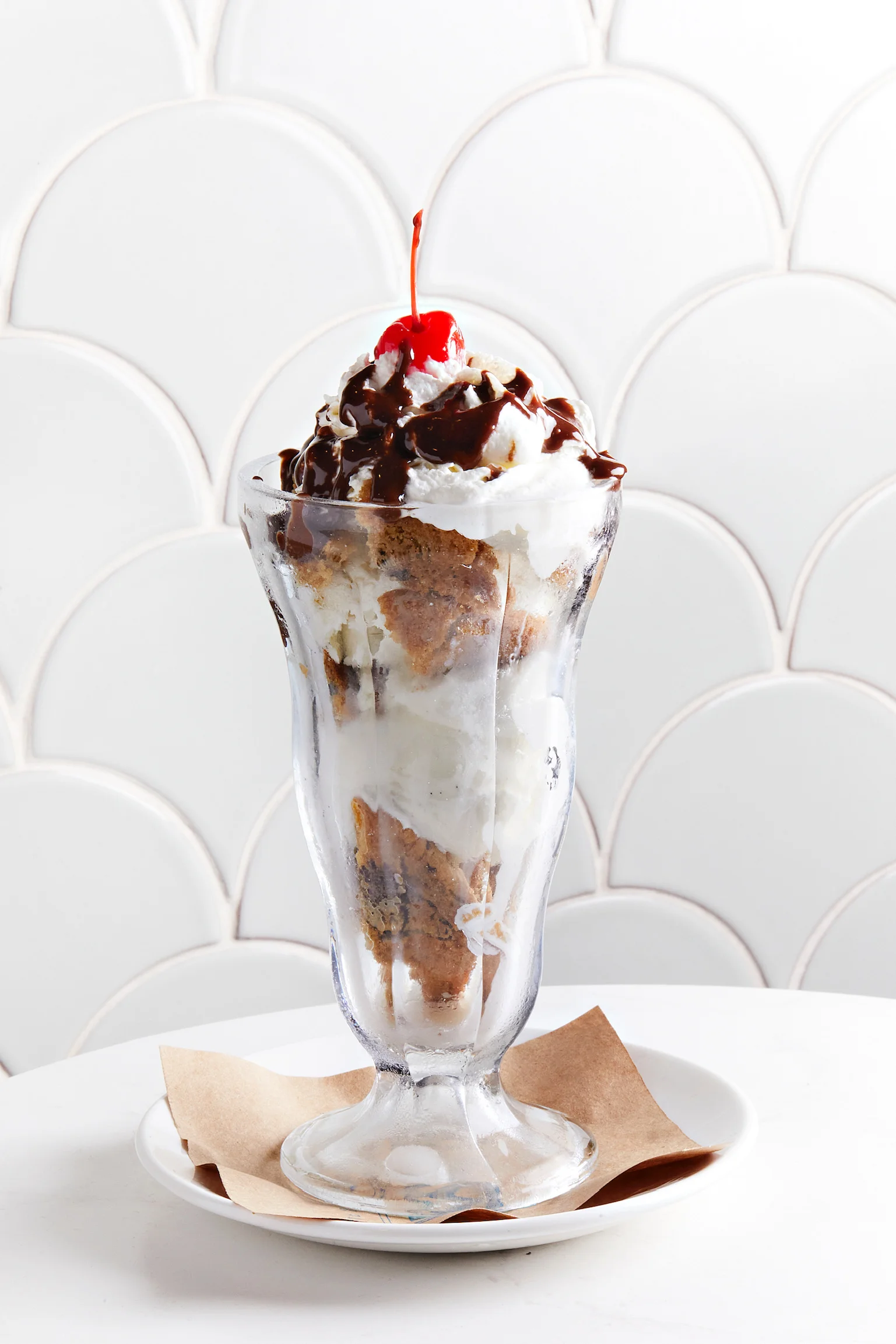 Classic American sundae topped with whipped cream and a cherry