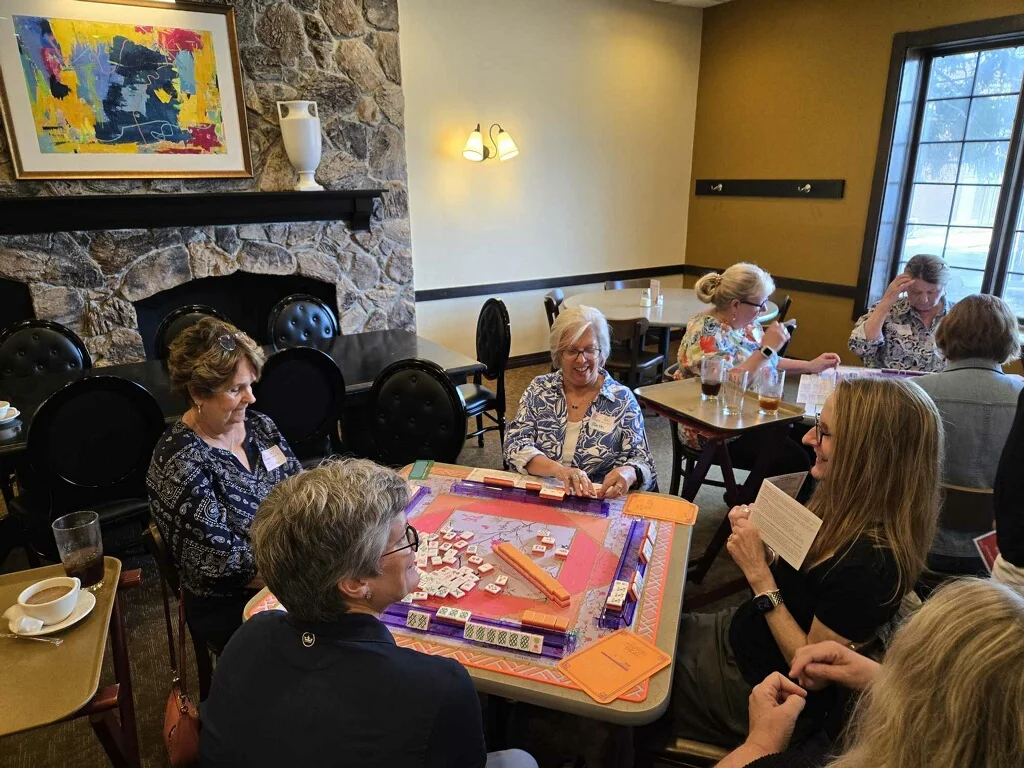 Group of friends enjoying a game night in a cozy restaurant setting