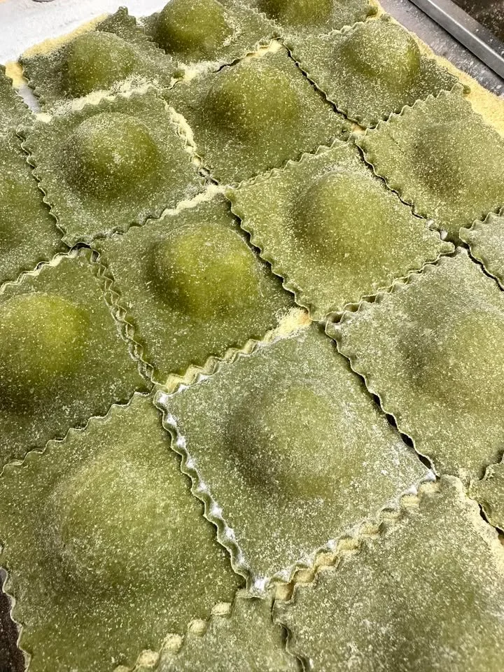 Freshly made spinach ravioli ready for cooking