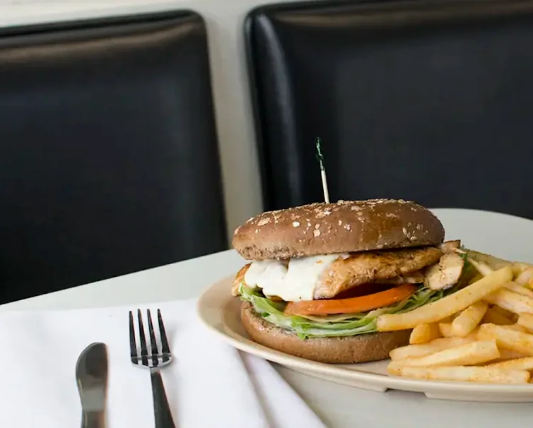 Delicious gourmet burger with fresh toppings on a wooden table