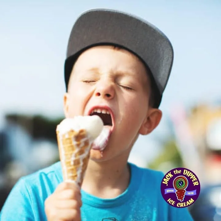 Child enjoying a classic ice cream cone on a sunny day