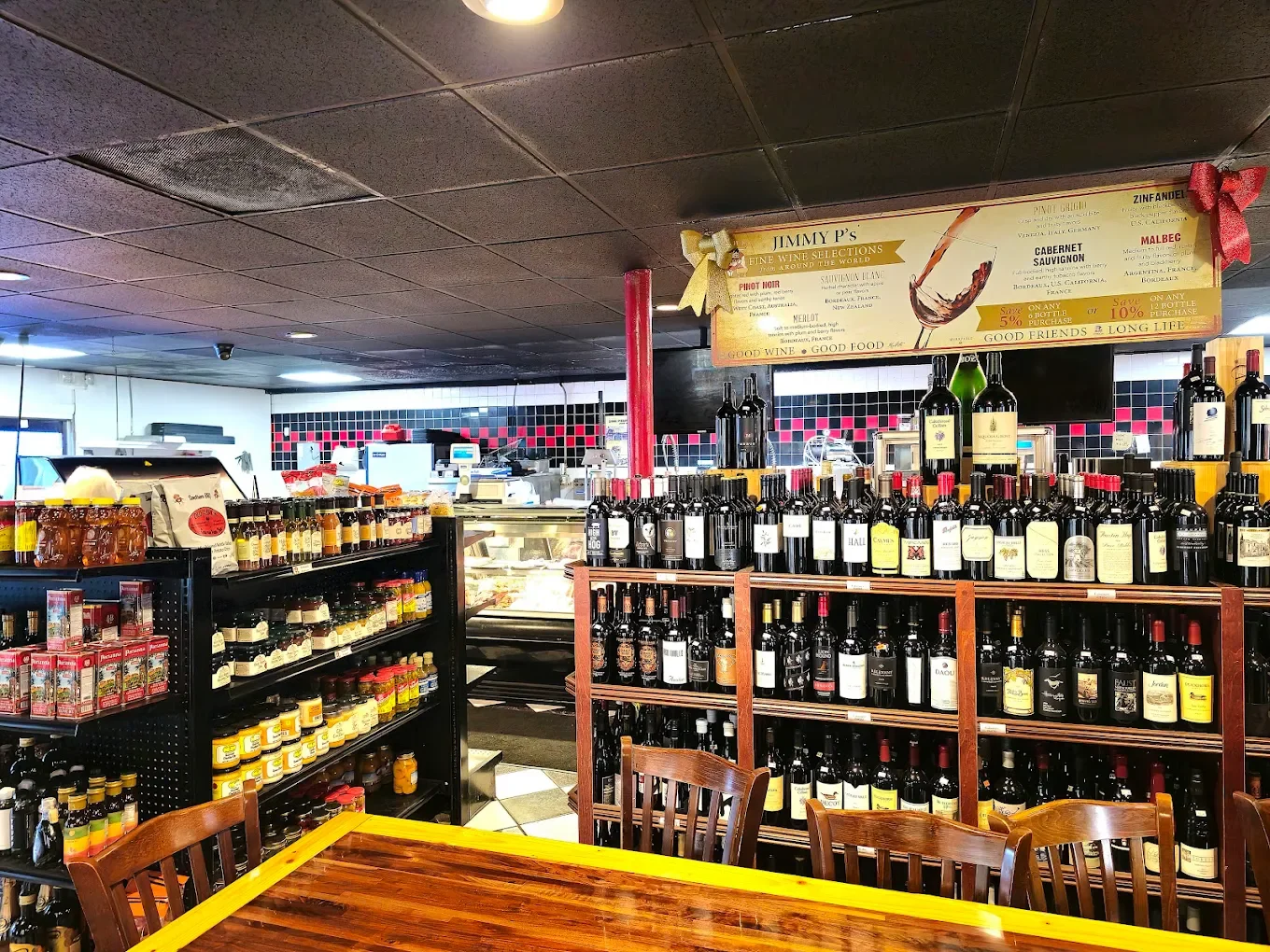 Cozy restaurant interior with wine selection and shelves of gourmet products