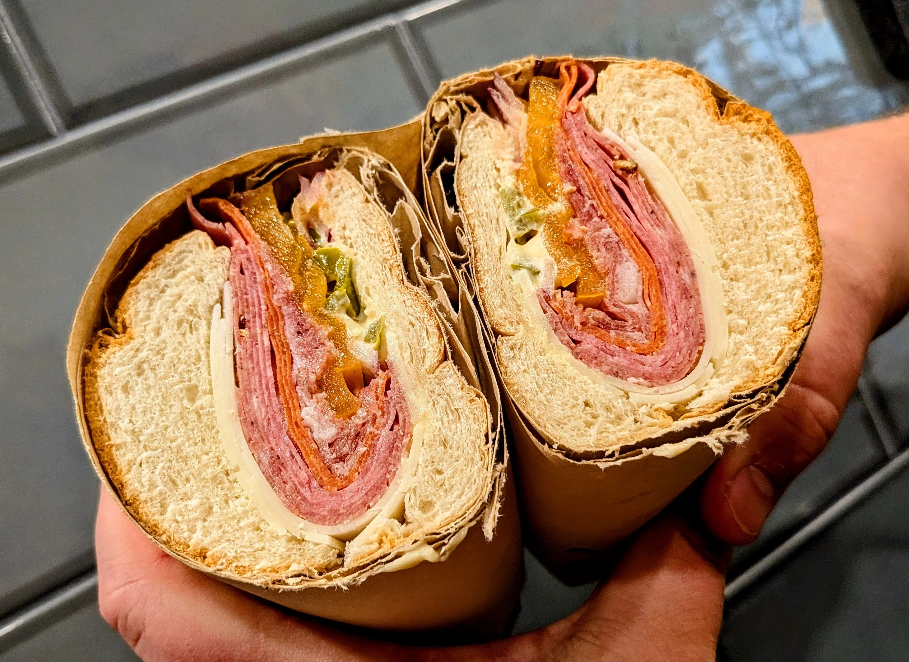 Italian sub sandwich with layers of meats and cheese