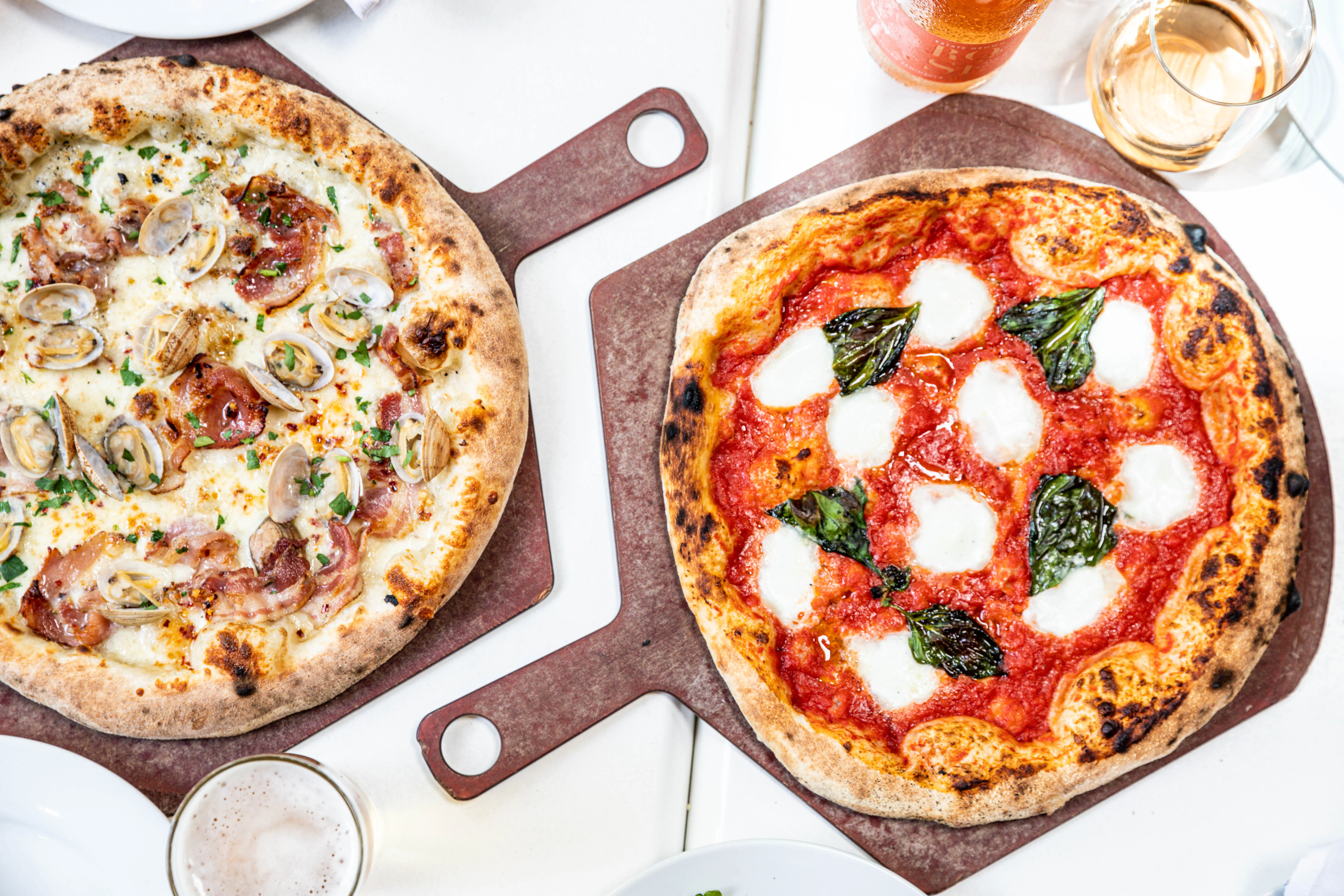 Two gourmet pizzas: clam pizza and Margherita pizza