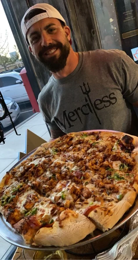Large BBQ chicken pizza served in a restaurant