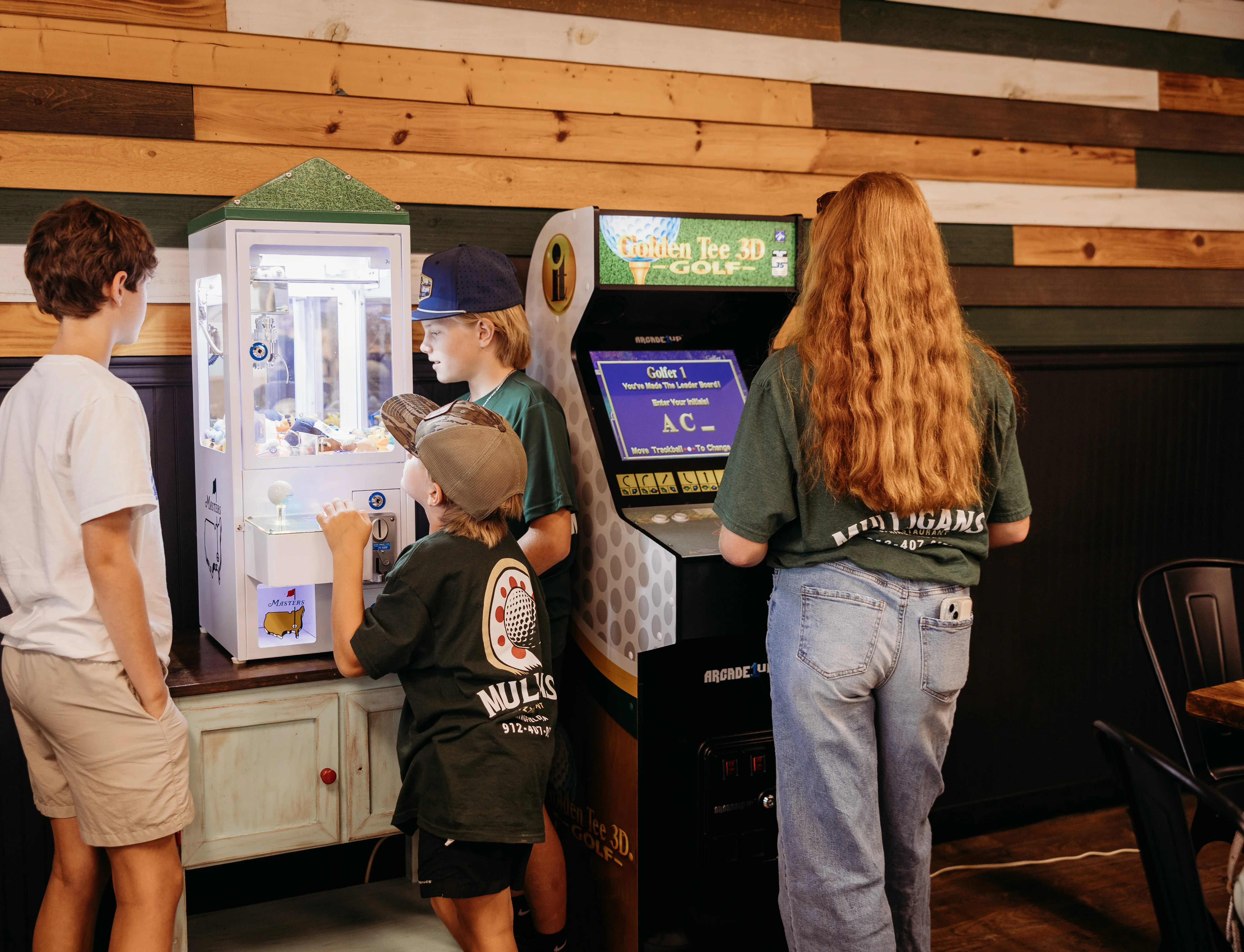 Kids enjoying arcade games in a vibrant restaurant setting
