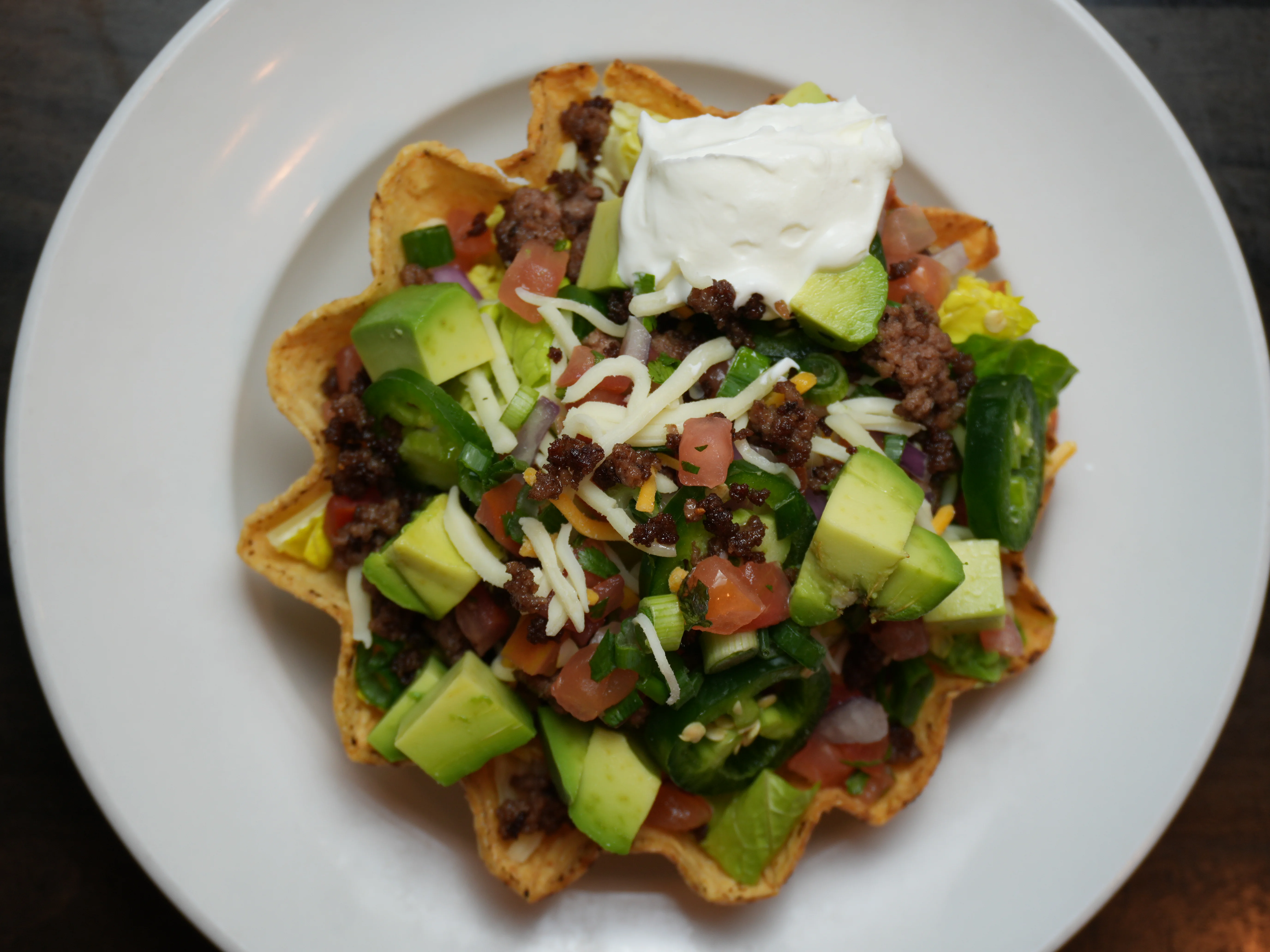 Mexican taco salad in a crispy tortilla bowl