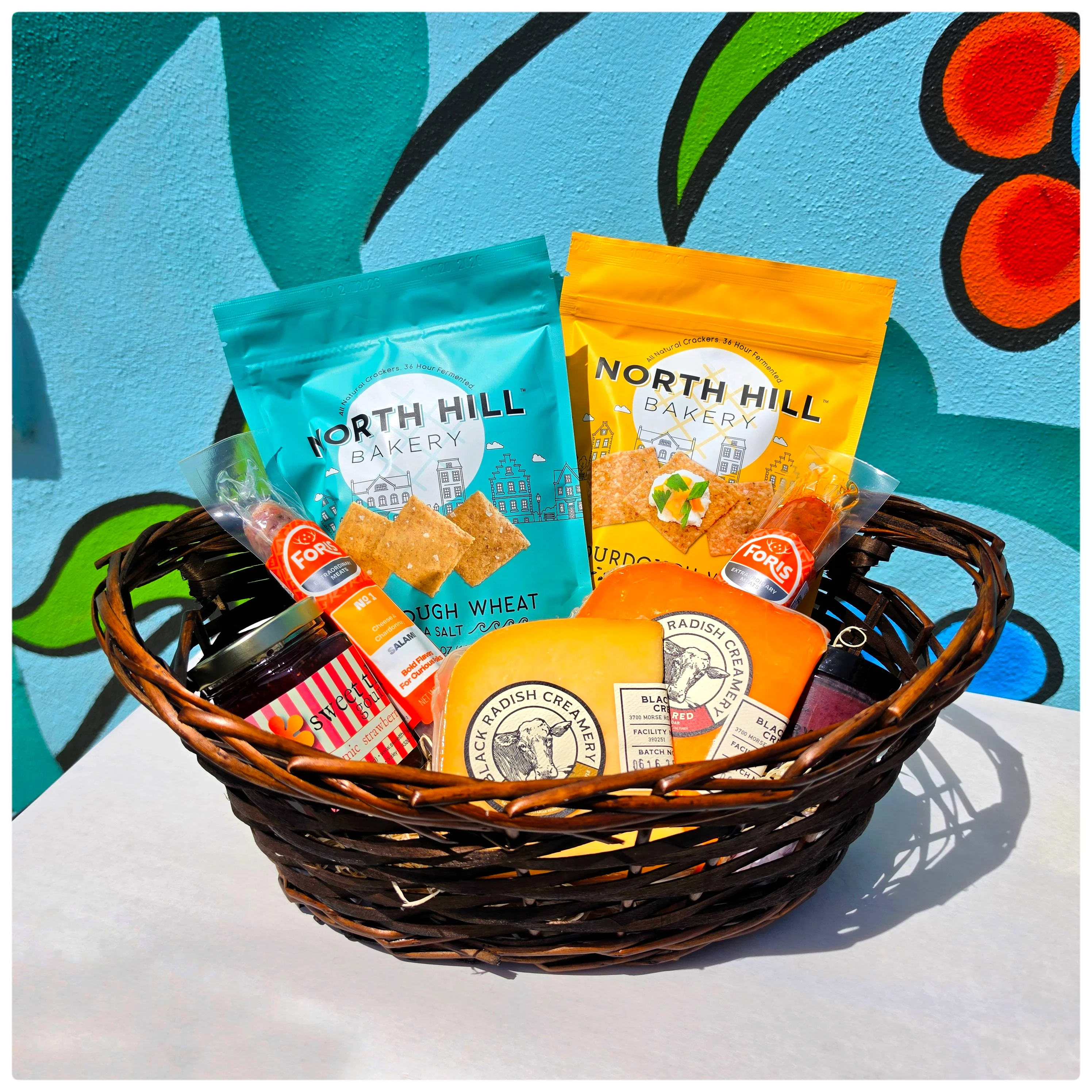 Artisan snack basket with gourmet crackers and cheese