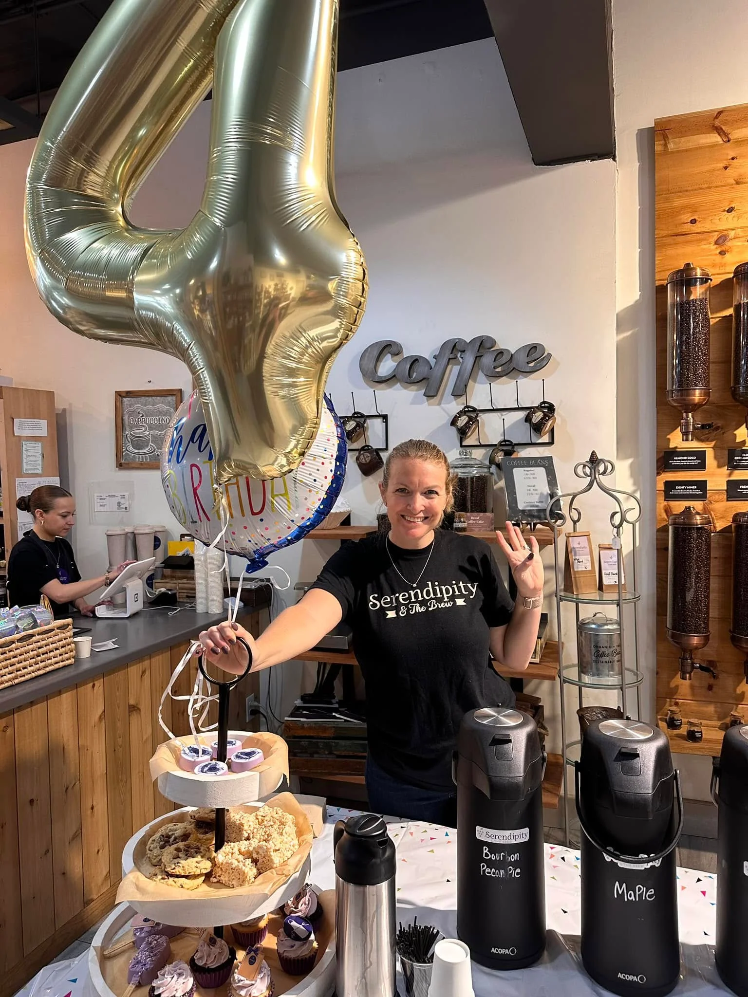 Celebration at a coffee shop with desserts and balloons