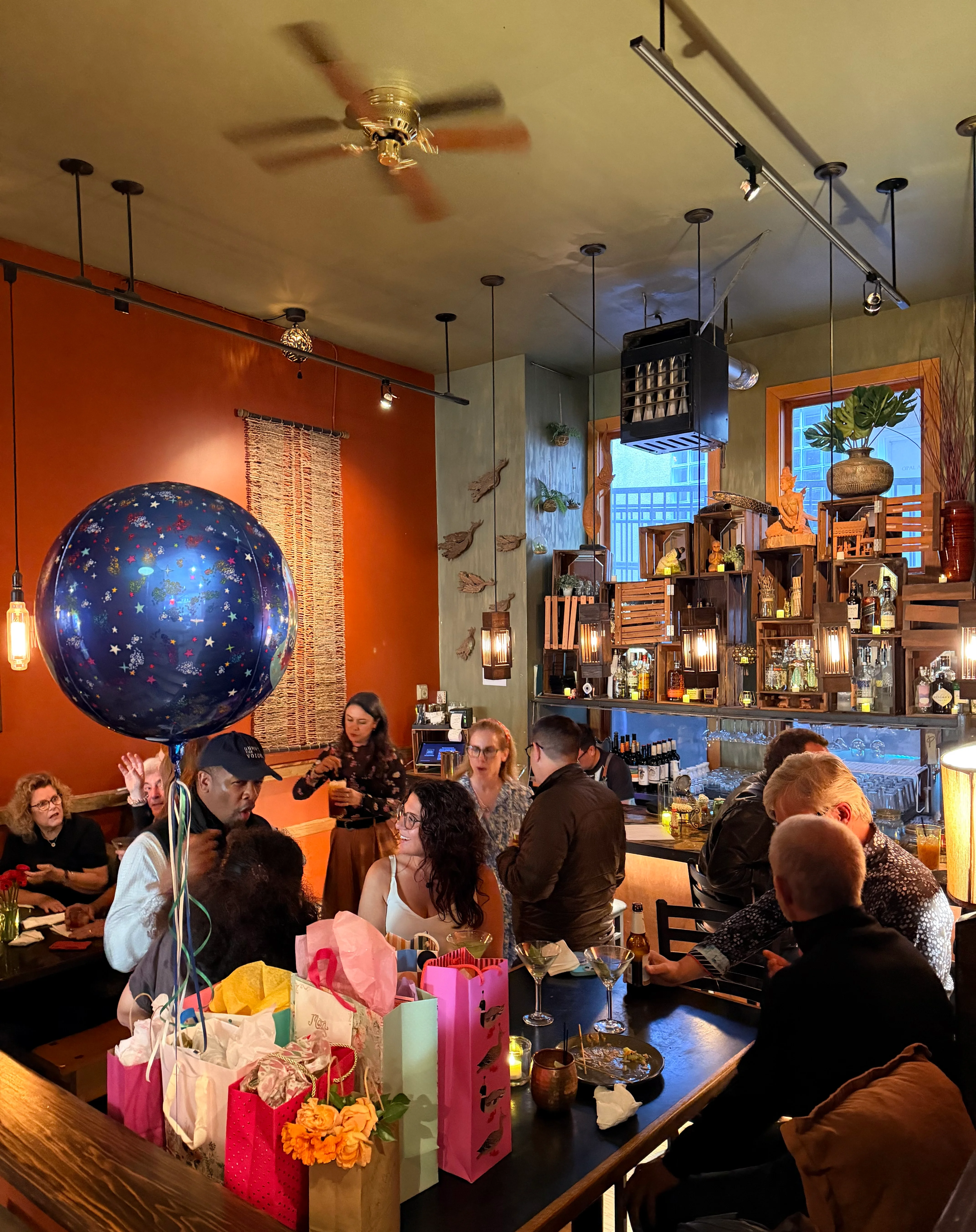 Cozy restaurant interior with festive decorations and guests celebrating