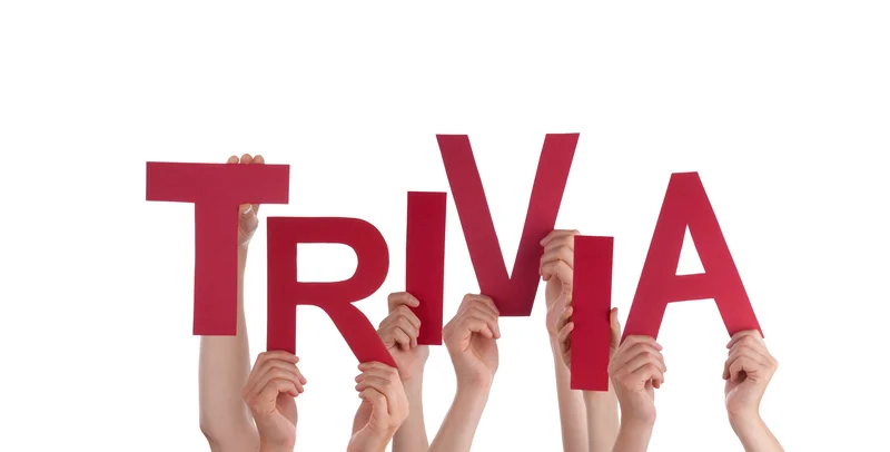 Hands holding letters spelling 'TRIVIA' in red on a white background