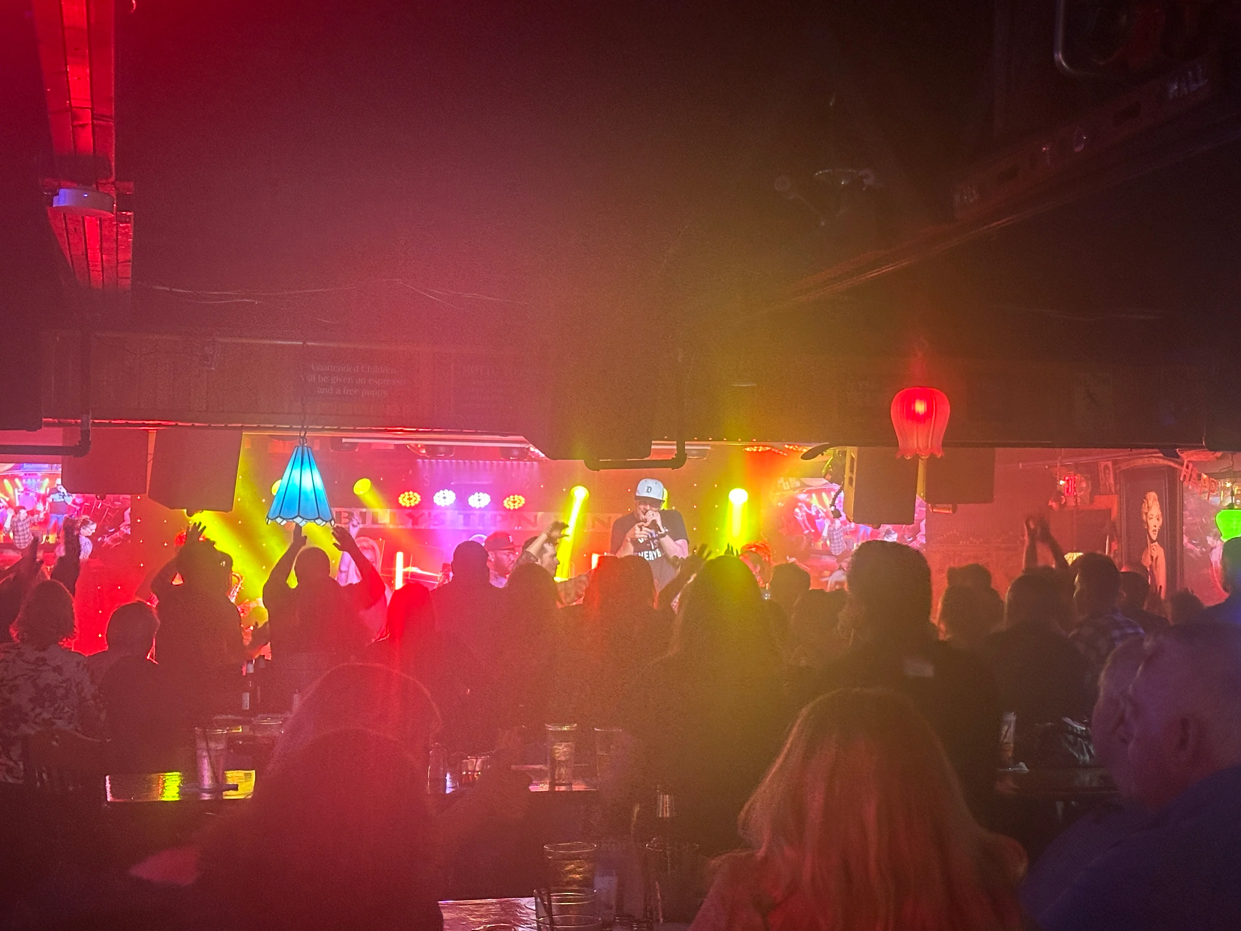 Live band performing on stage with vibrant lights