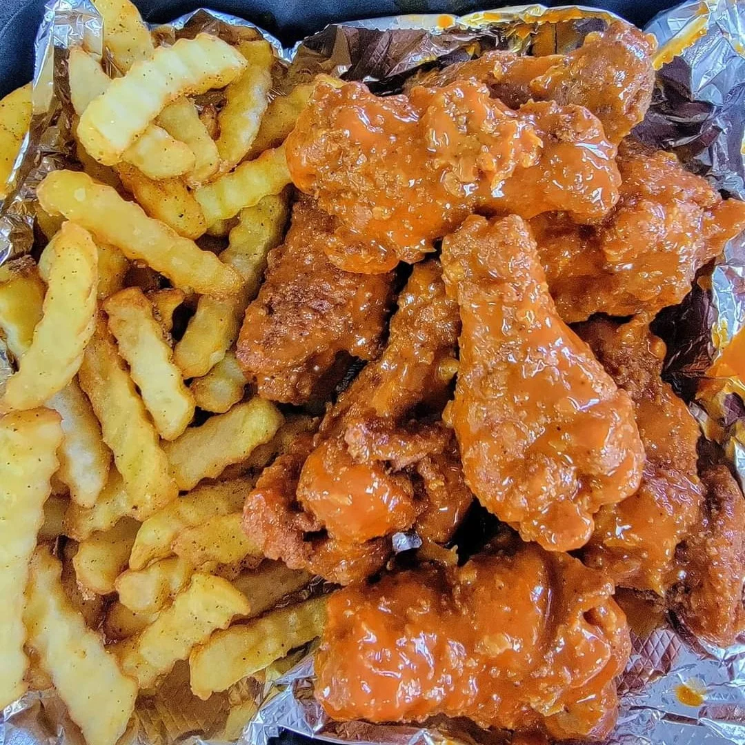 Crispy buffalo chicken wings with crinkle-cut fries