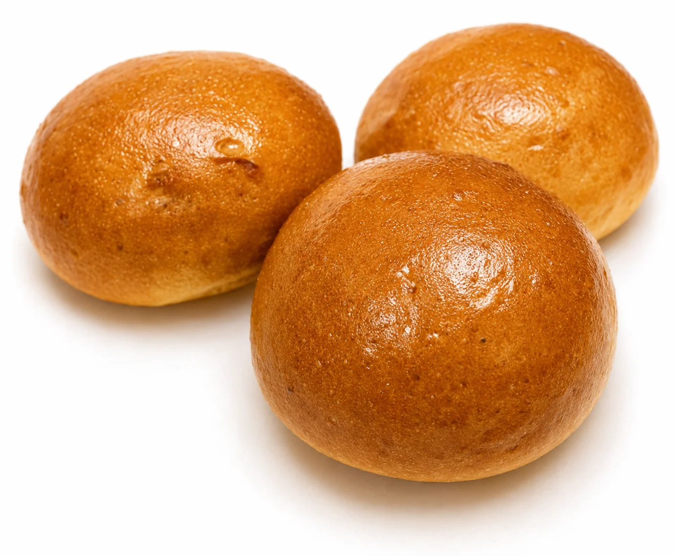 Three golden-brown, round baked goods on a white background.