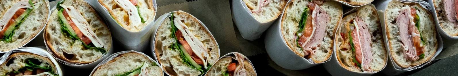 Gourmet deli sandwiches wrapped for takeout