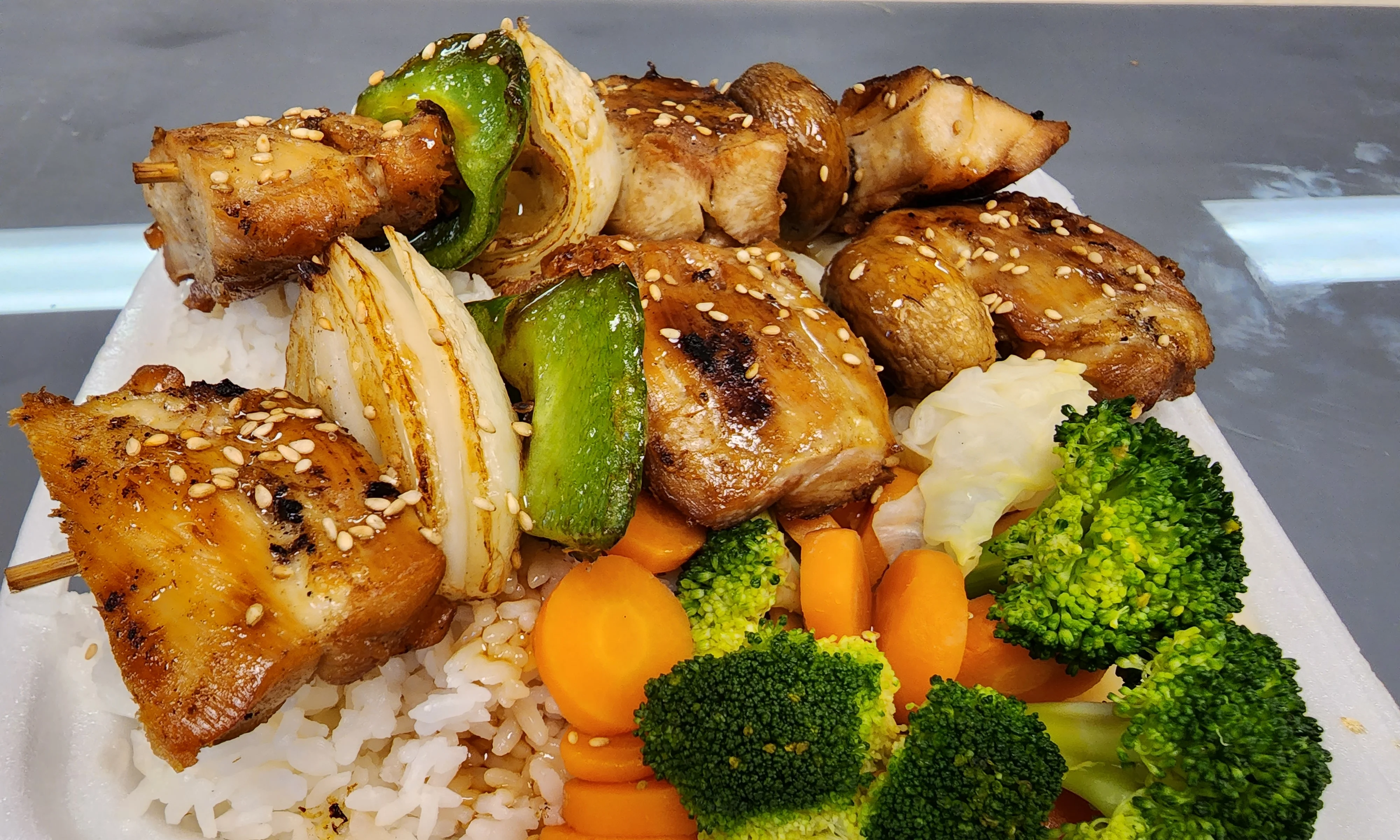 Grilled chicken teriyaki rice bowl with vegetables