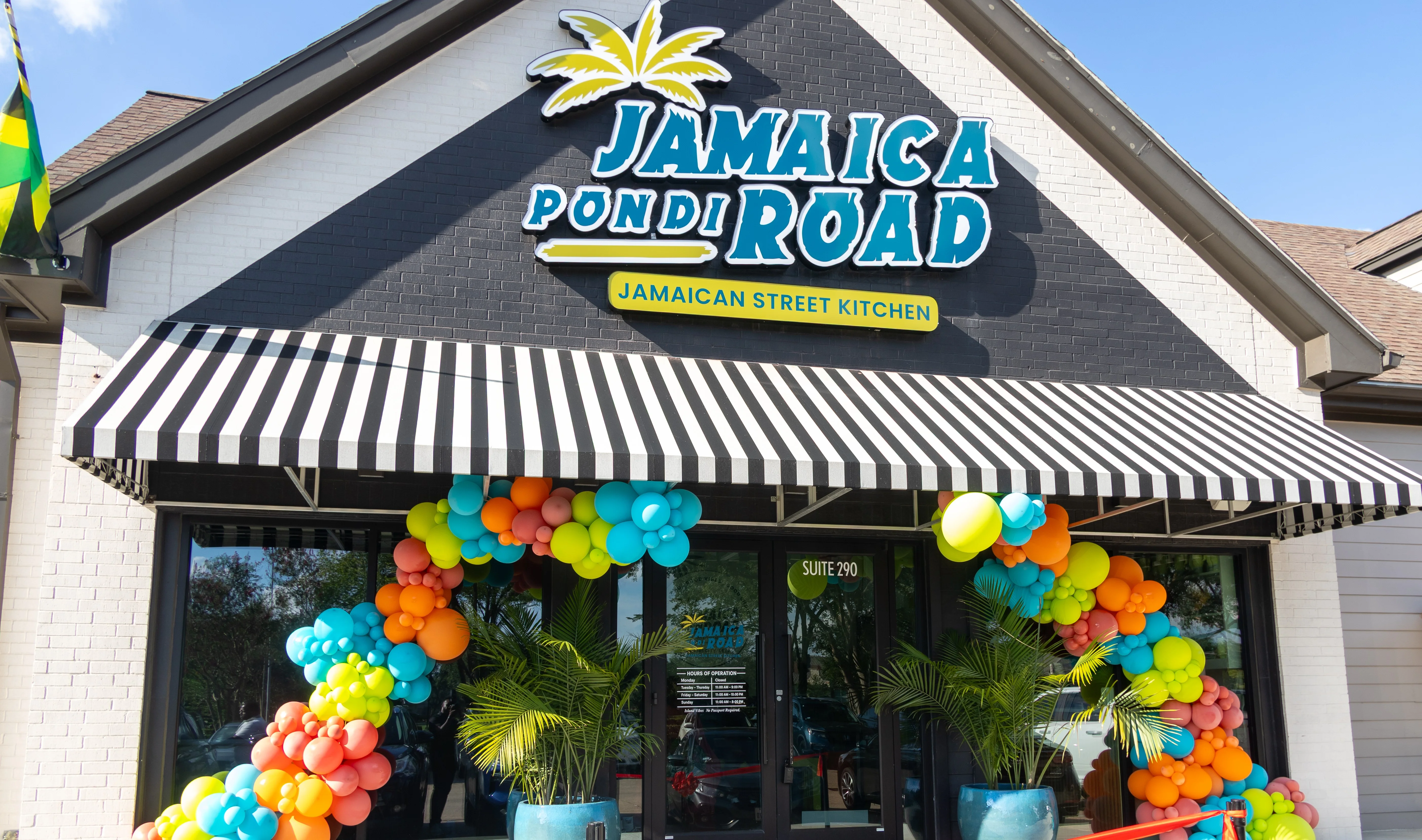 Colorful balloon-decorated Jamaican restaurant storefront