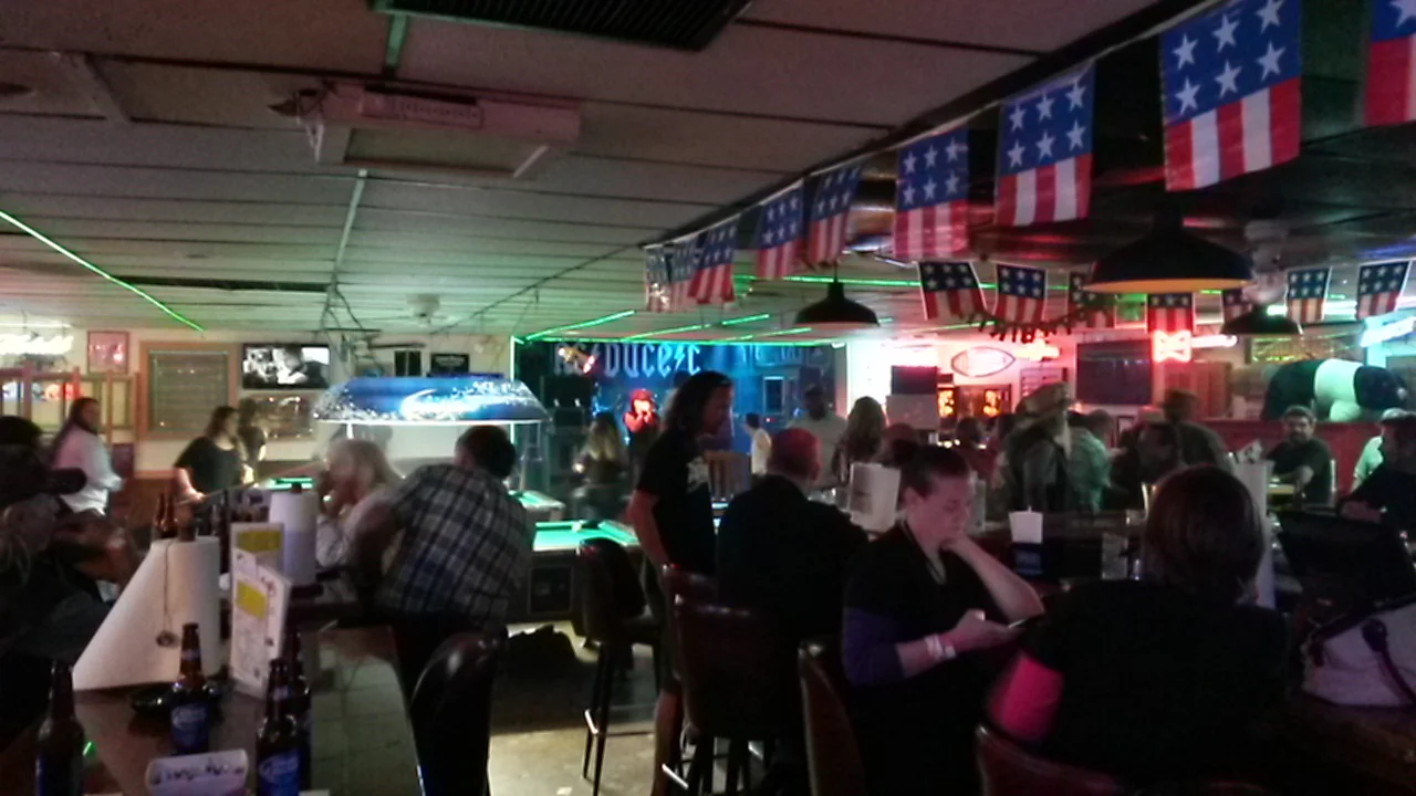 Lively bar interior with American flags and neon lights