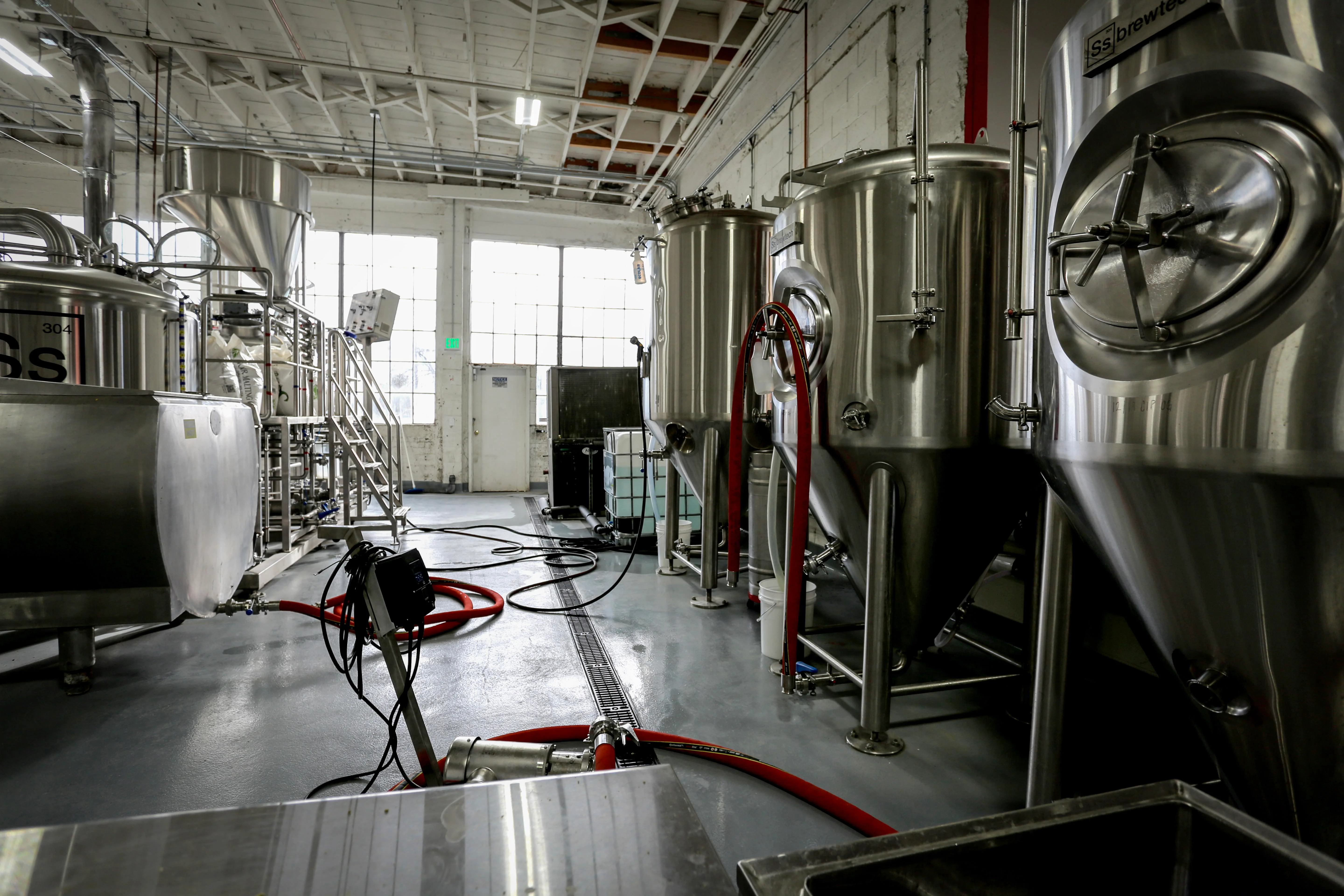 Black and white brewery with red vintner hoses