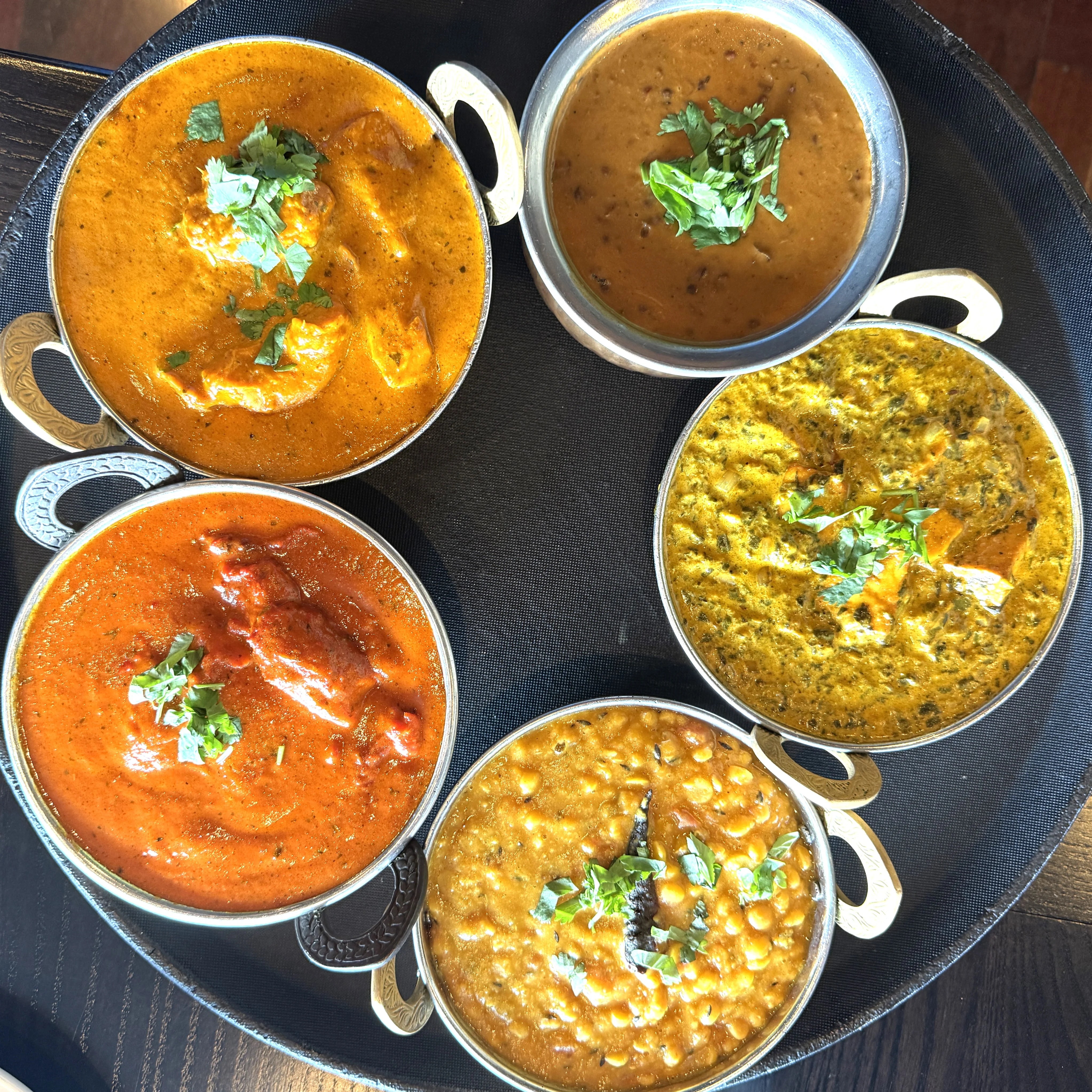 Assorted Indian curries served in traditional bowls