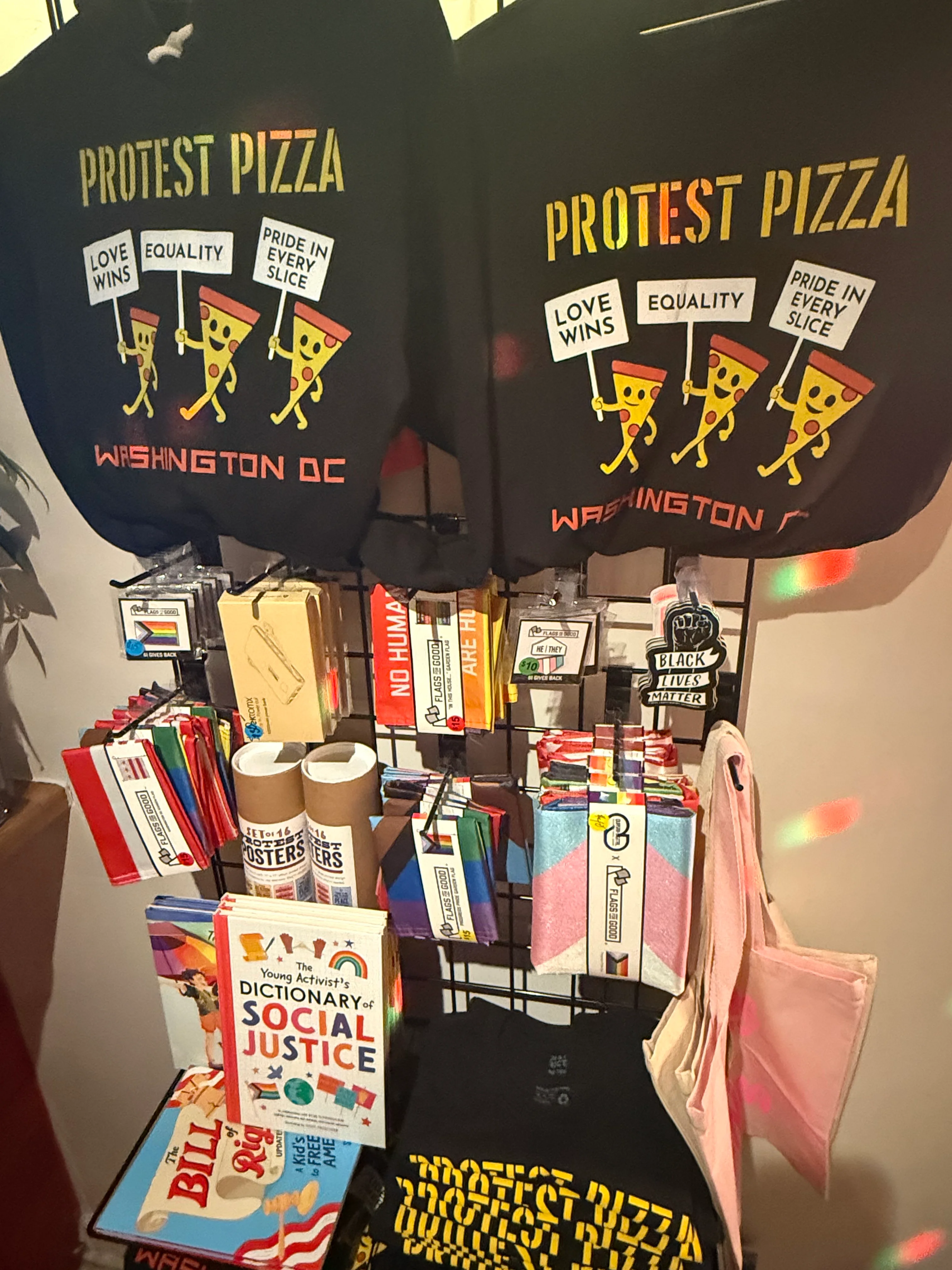 Merchandise display featuring protest-themed items and social justice books