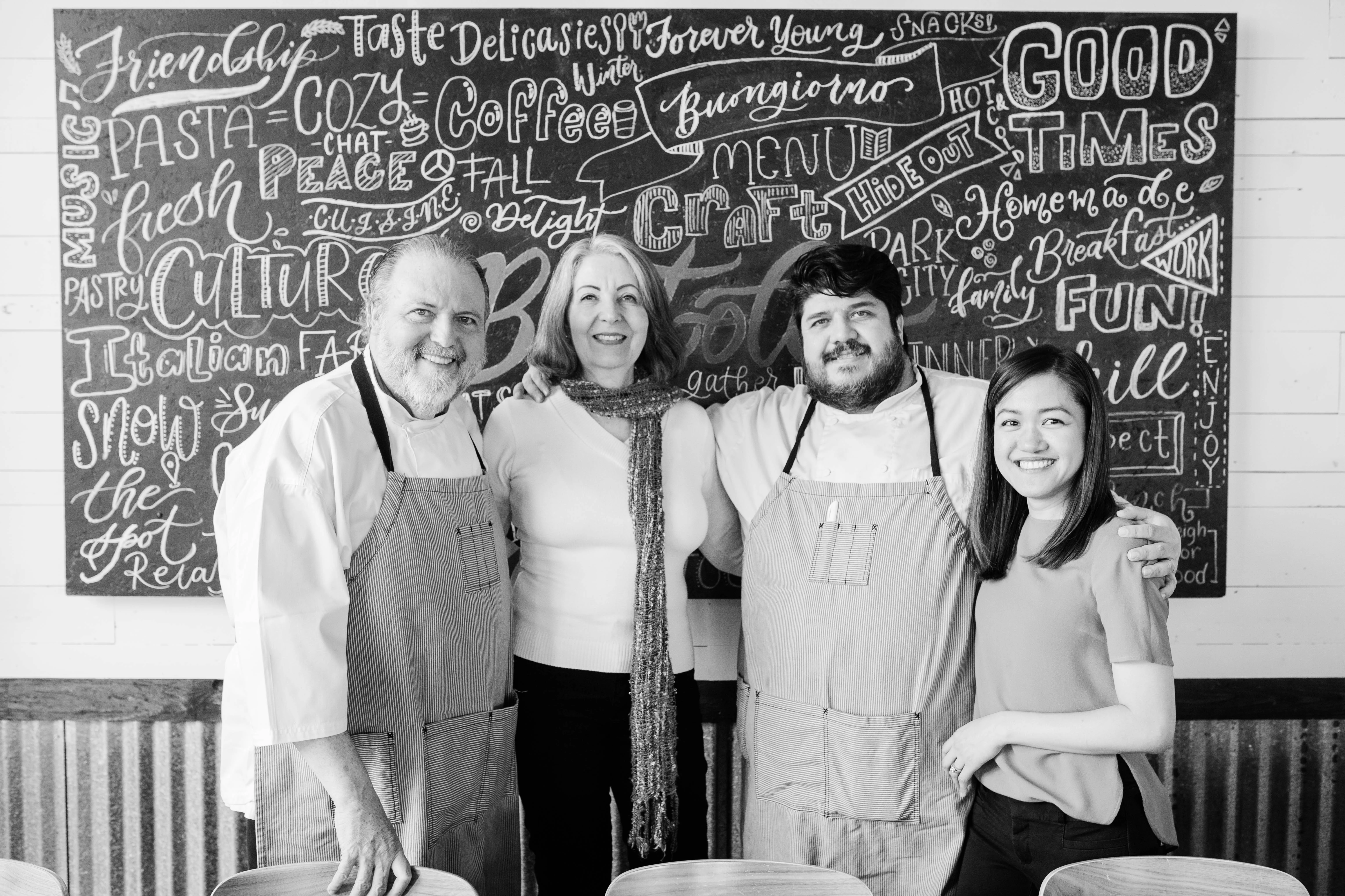 Chefs and staff posing in a cozy restaurant setting