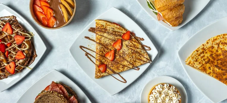 Delicious French crepes with strawberries and chocolate drizzle