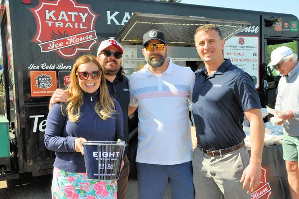 Group posing outside a Katy Trail ice cream truck at a food festival