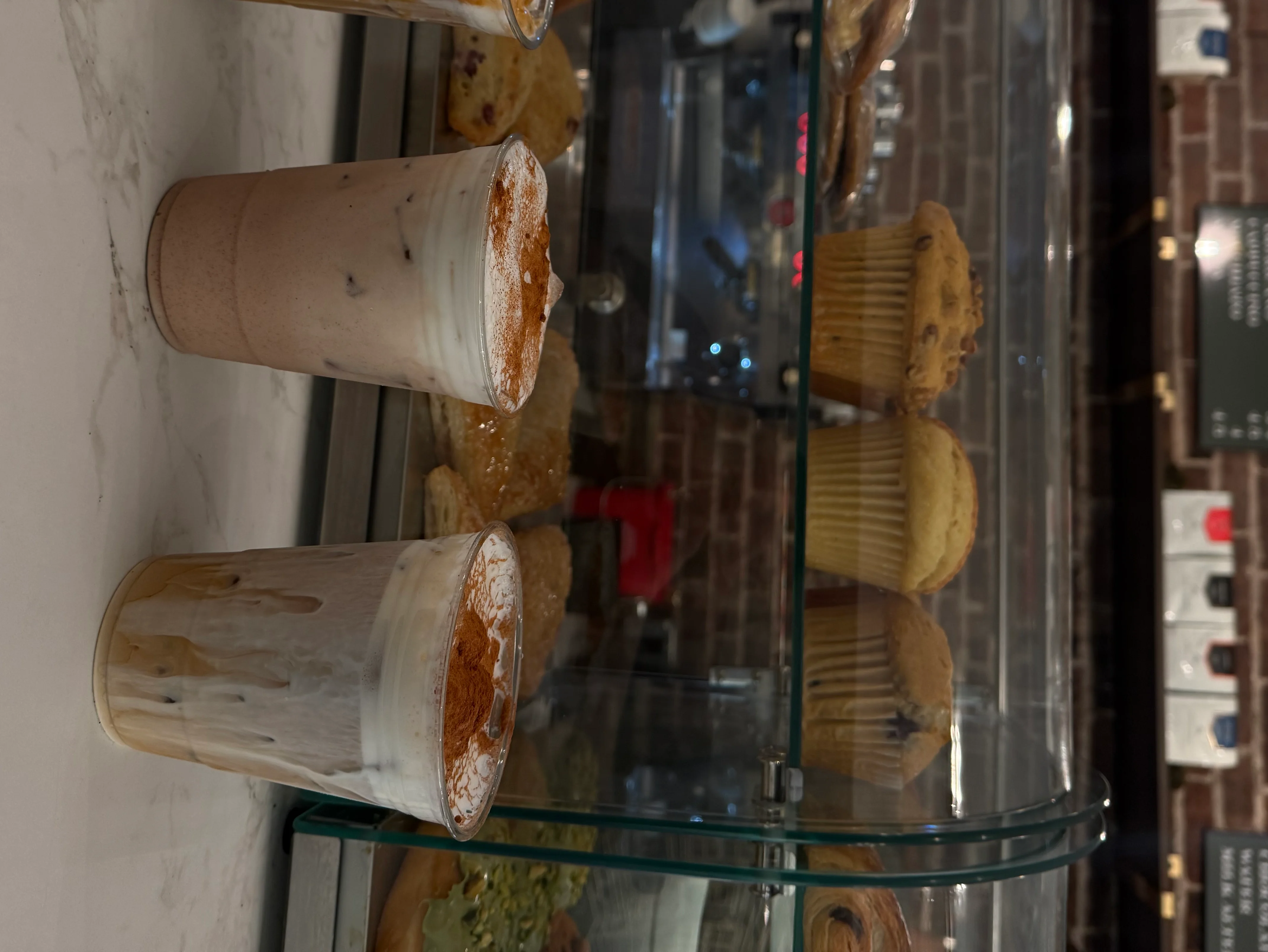 Iced coffee drinks with whipped cream in a cozy café setting