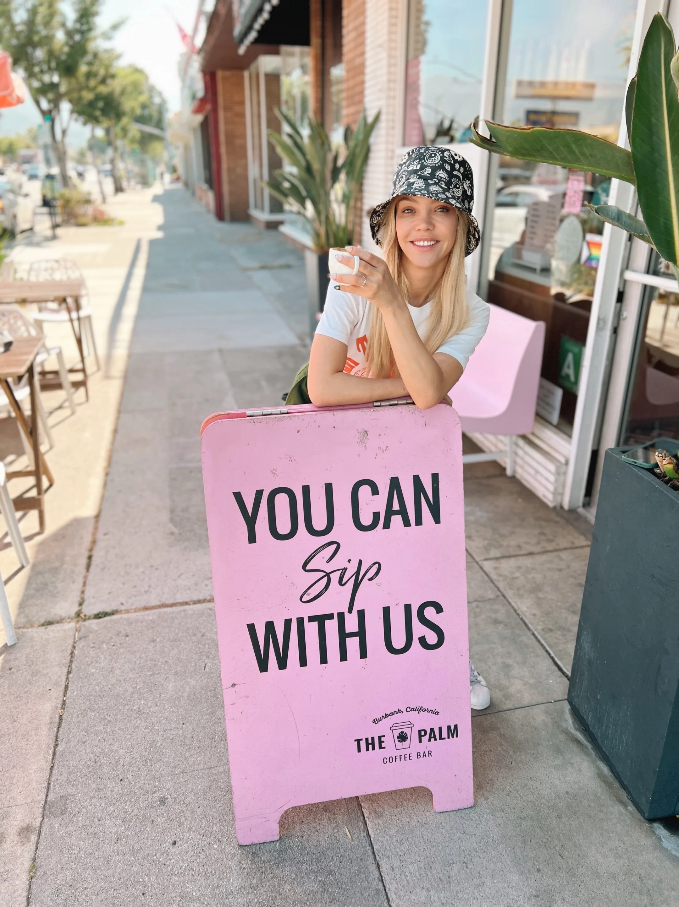 Cold brew coffee in a cup with a pink logo on it
